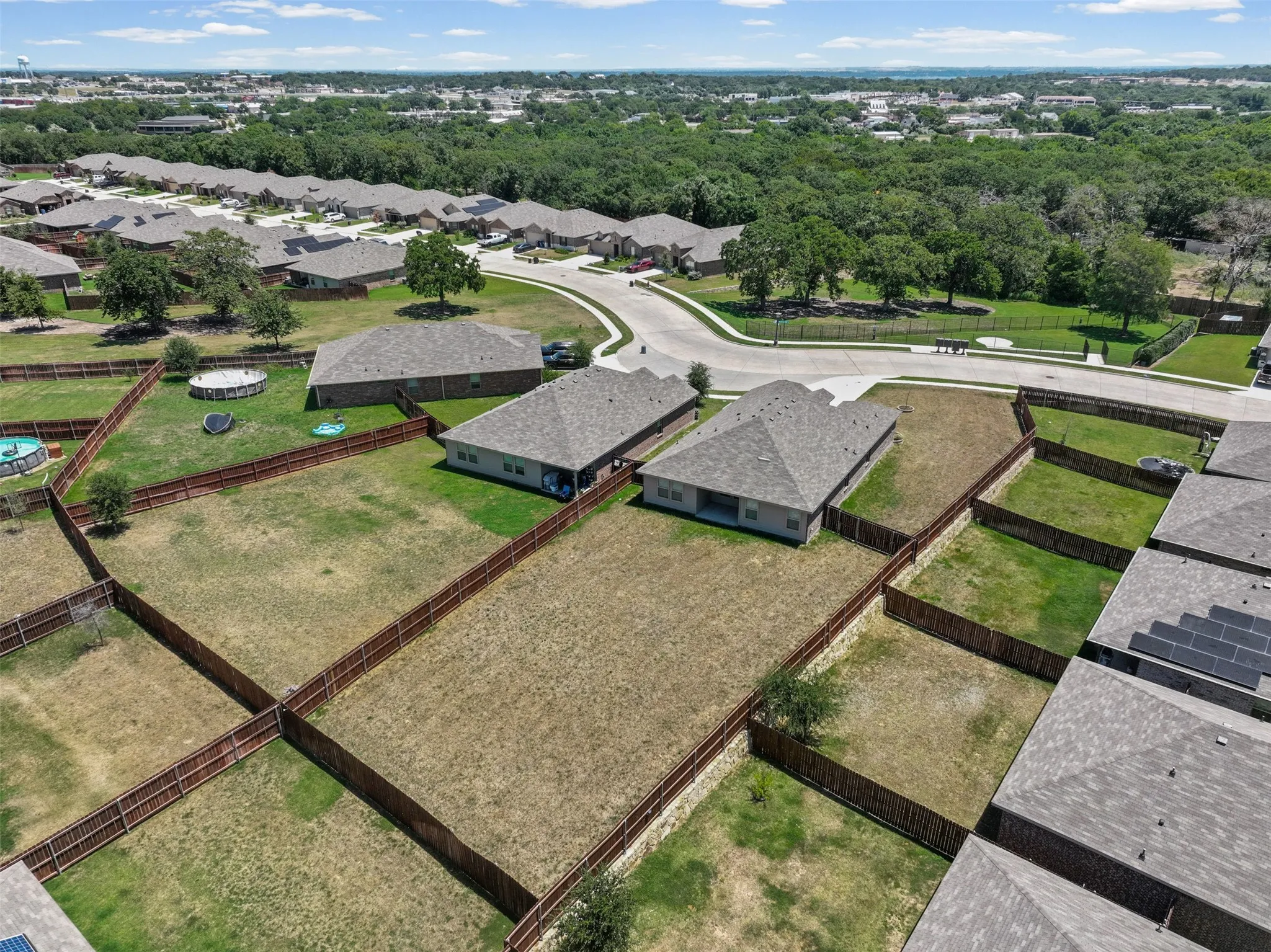 Expansive residential lot featuring a perimeter fence and clear land