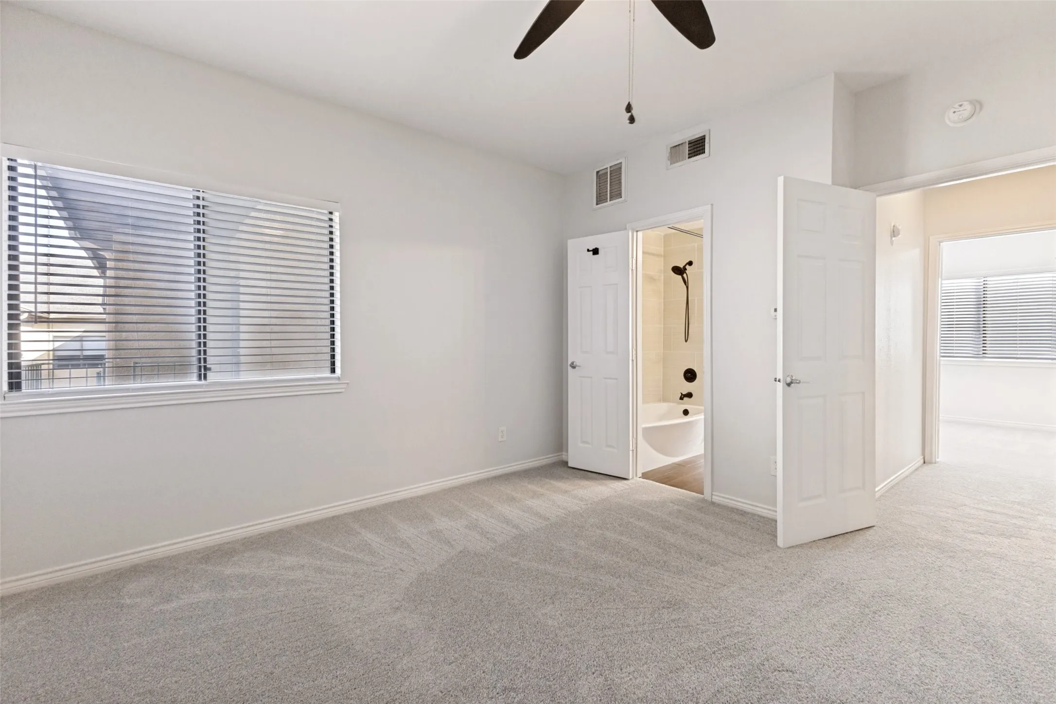 Neutral color palette featuring soft grey carpeting, white walls, and white trim