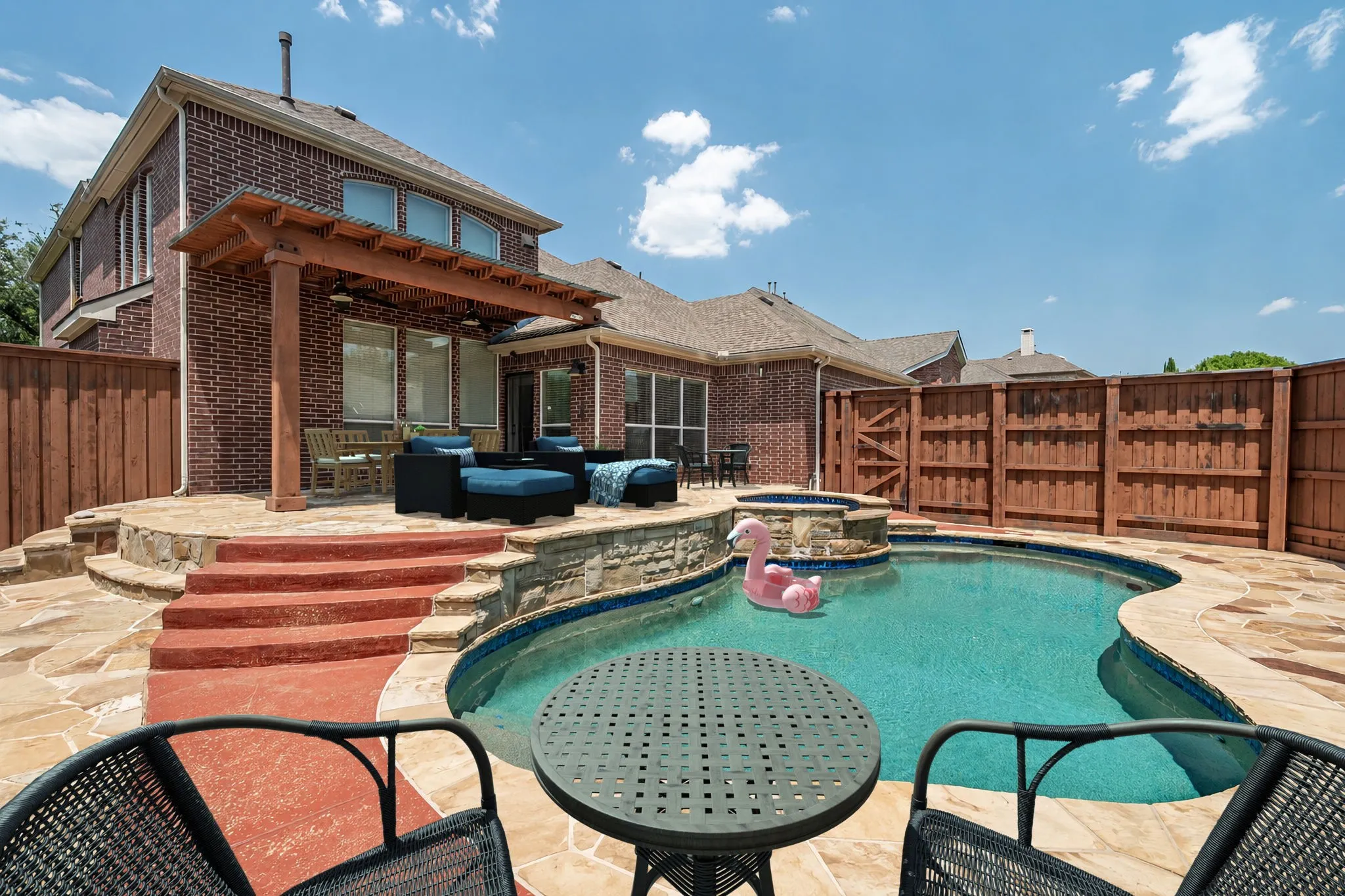 Stunning Back Yard Pool With Multiple Seating and Lounging Areas. Furniture And Pool Toy Have Been Virtually Staged.
