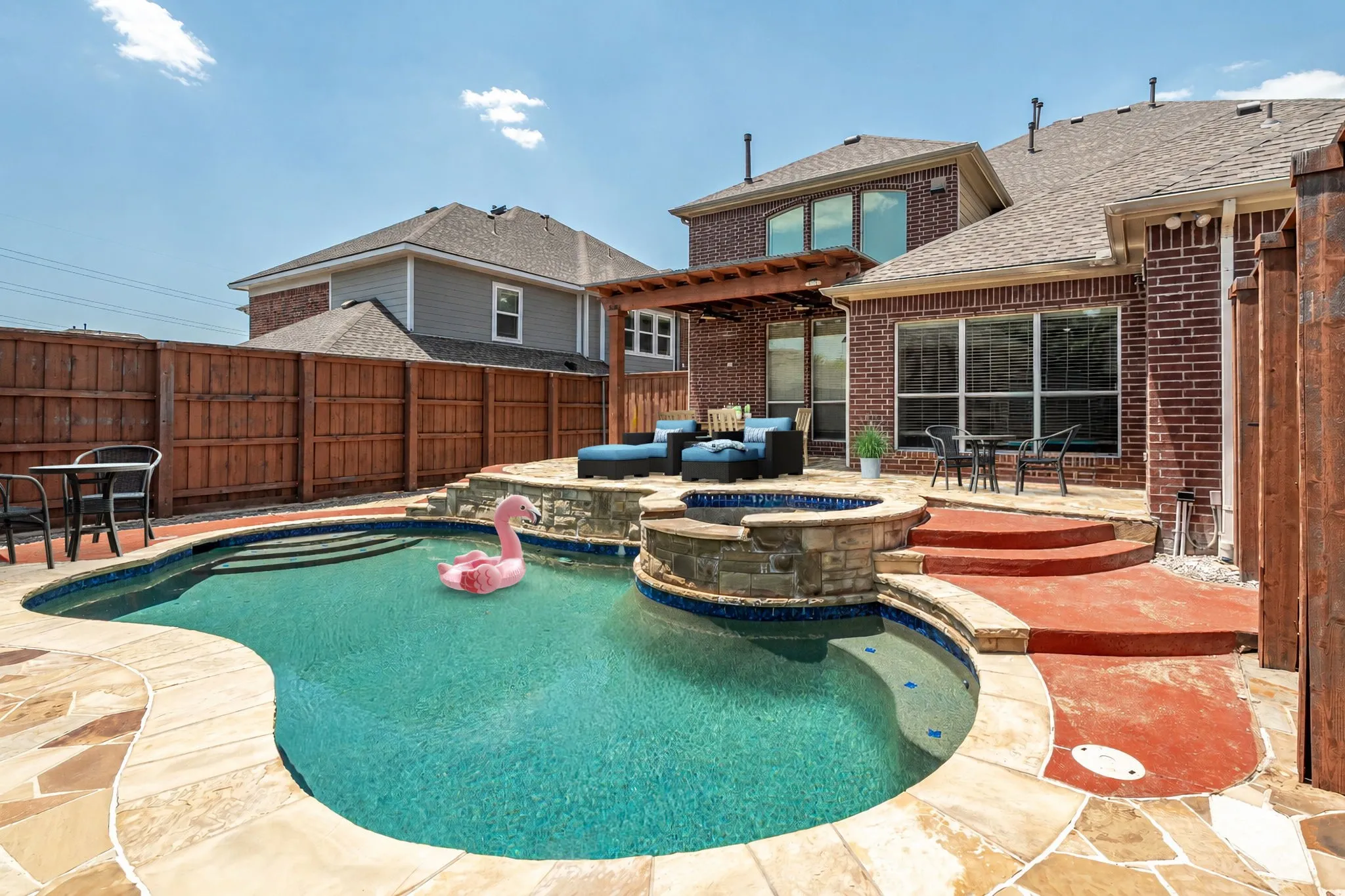 Back Yard Pool With Multiple Seating And Lounging Areas.  Board On Board Fence For Maximum Privacy.  Furniture And Pool Toy Have Been Virtually Staged.