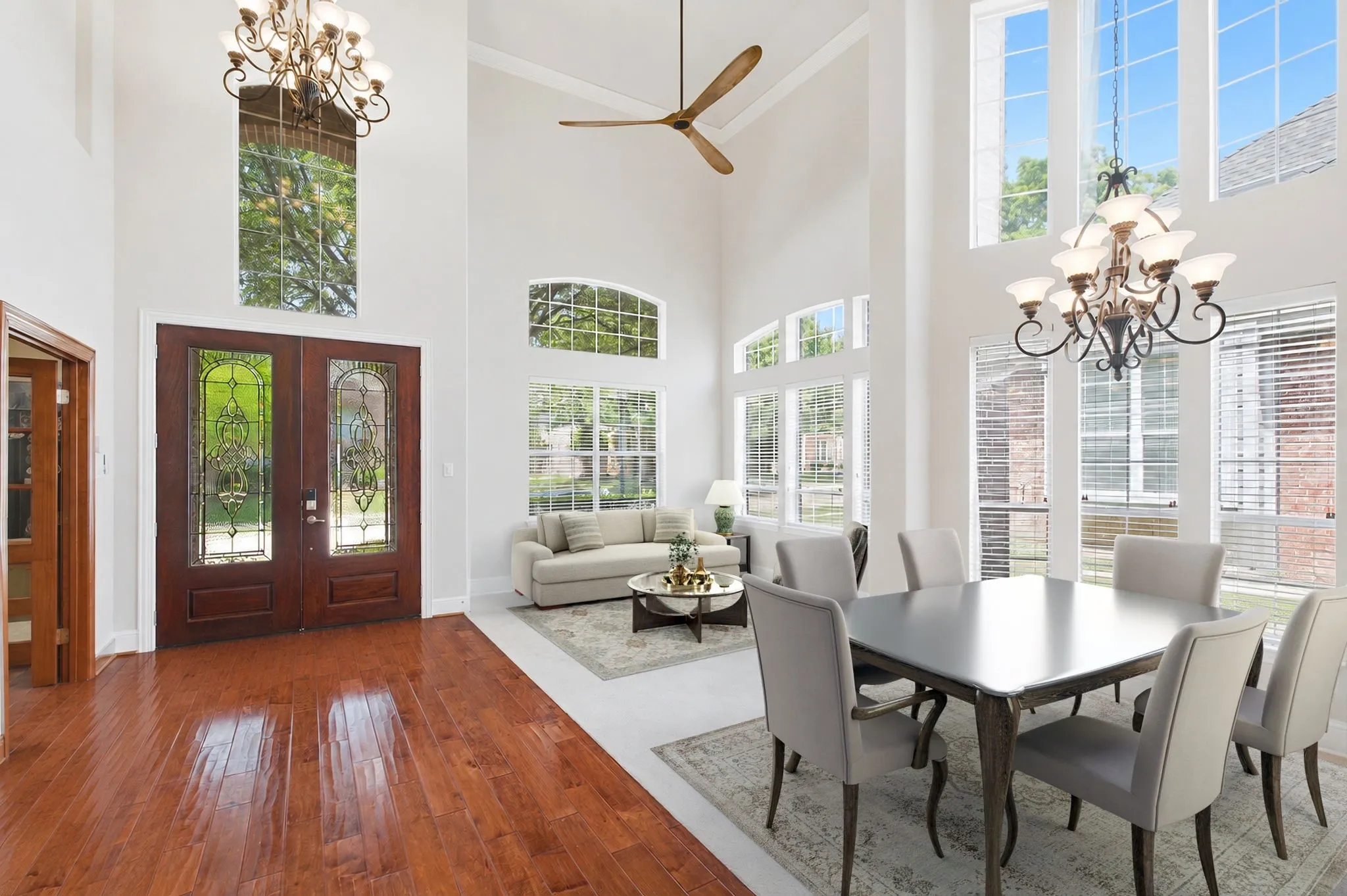Formal Dining And Living Room Showcasing The Double Door Entryway Which Has Been Virtually Staged.