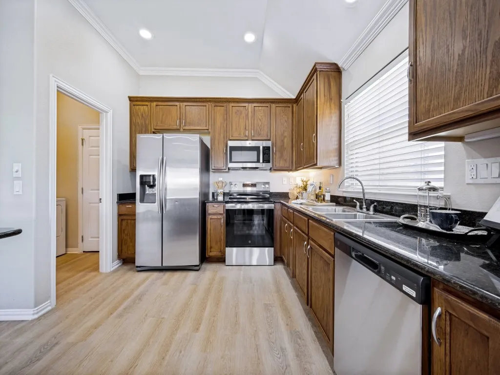 Granite countertops are Verde Ubatuba and cabinets are 42" stain-grade wood