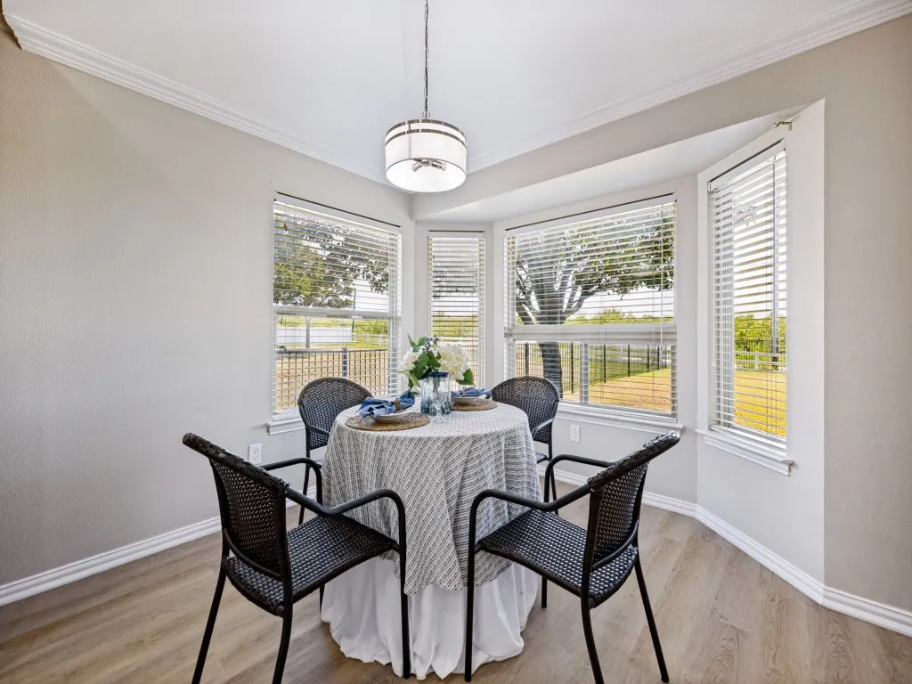 Bay windows extend the view in this dining area.