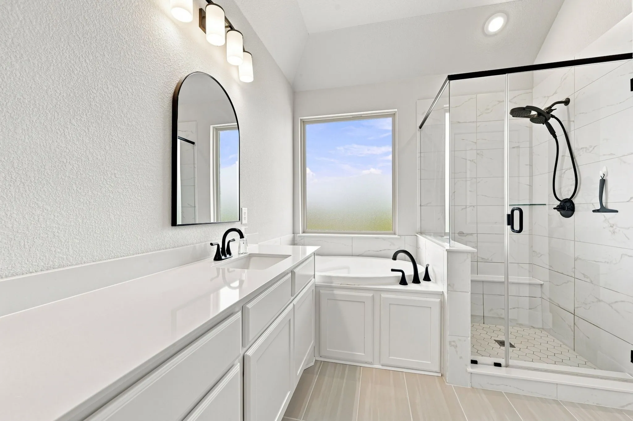 The primary bath also has dual sinks and a water closet.