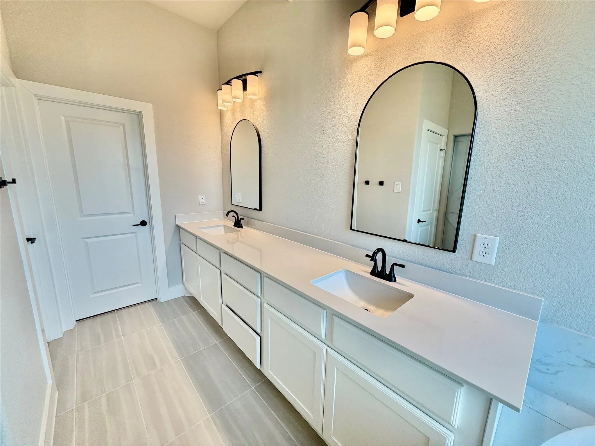 Another view with the dual sinks and the decorative mirrors.