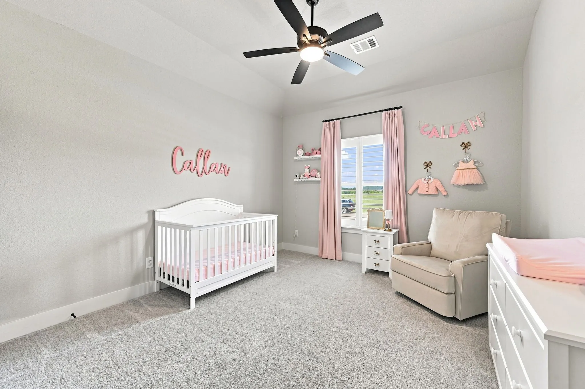 Darling bedroom with a ceiling fan, plantation shutters and walk in closet.