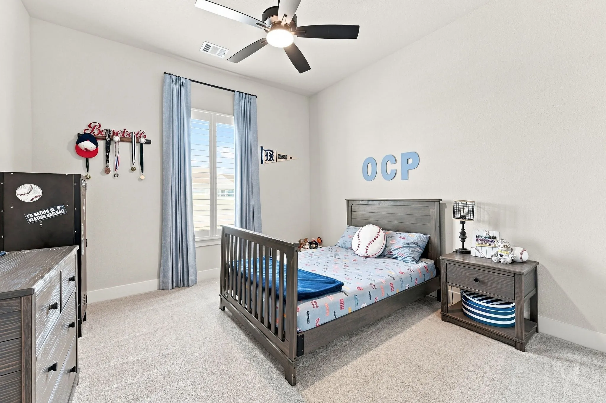 Cute bedroom has a walk in closet, ceiling fan and plantation shutters