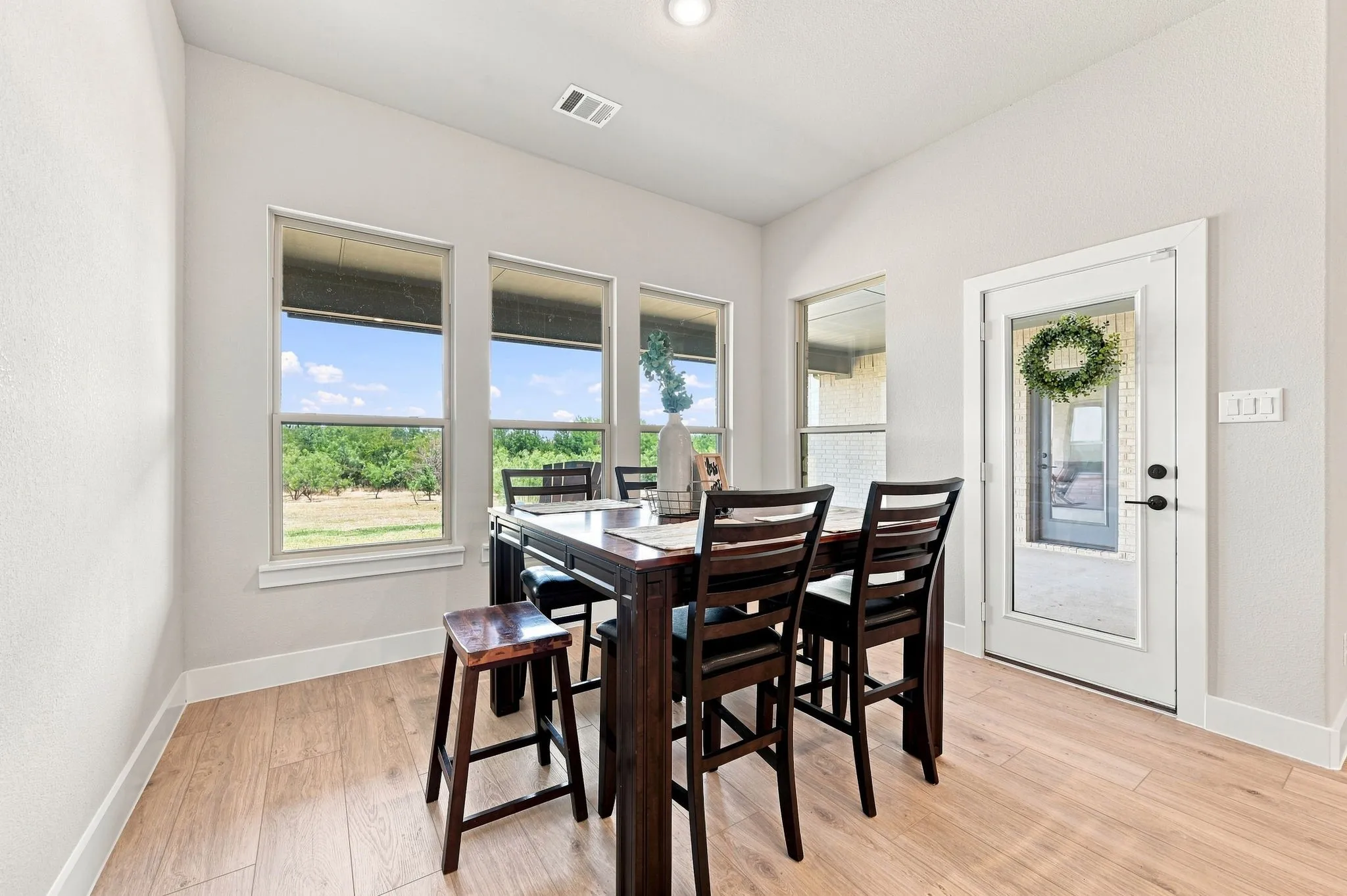 Good size dining space with a view to the backyard and a door that leads to the patio,.