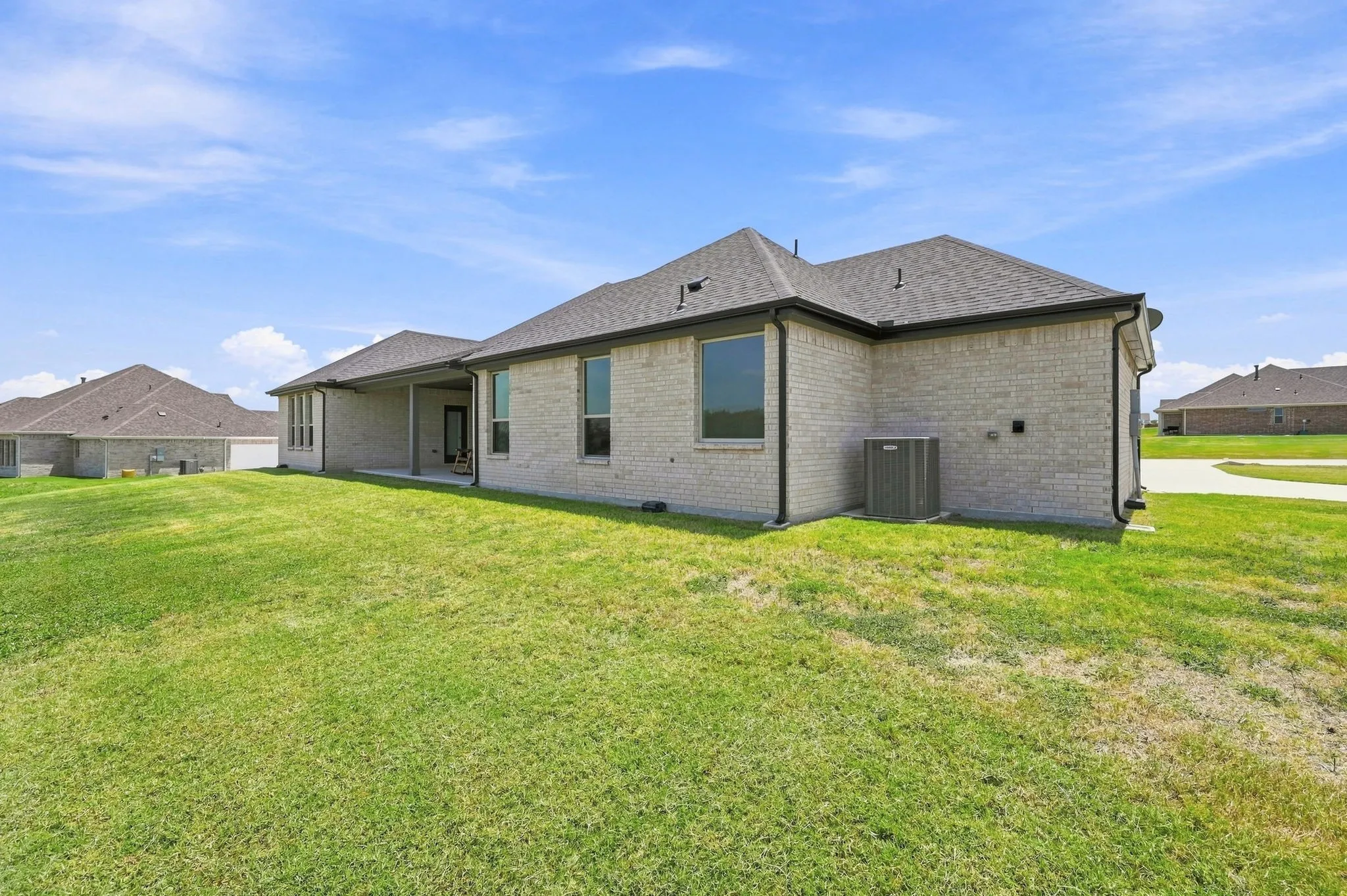 The back of the home is all brick with a spacious patio.