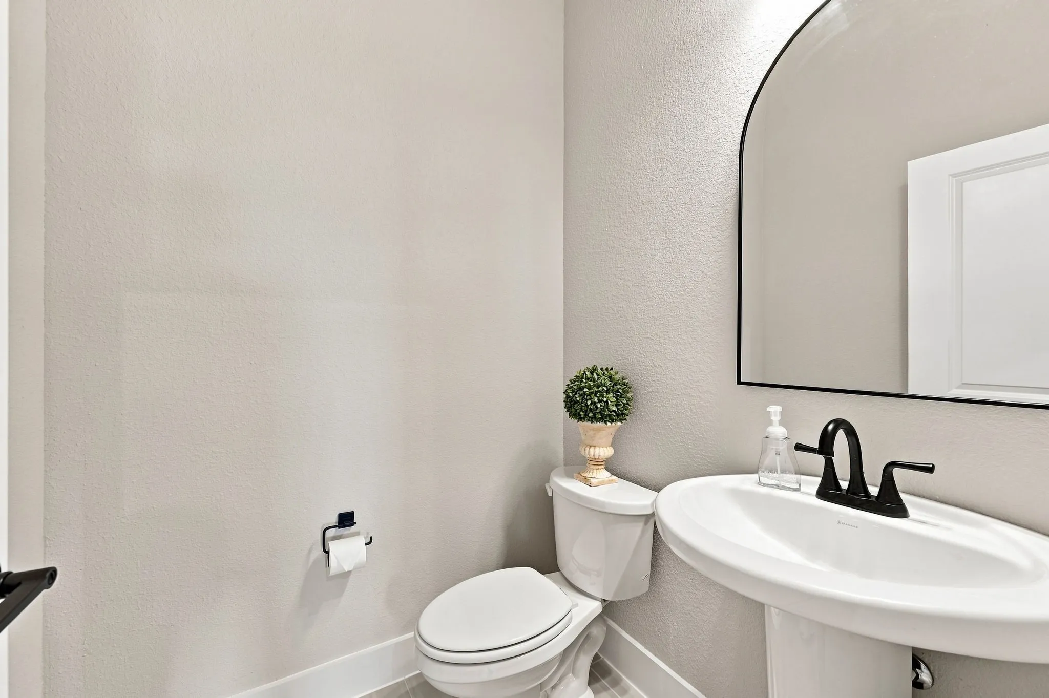 Half bath off the hallway leading to the garage.