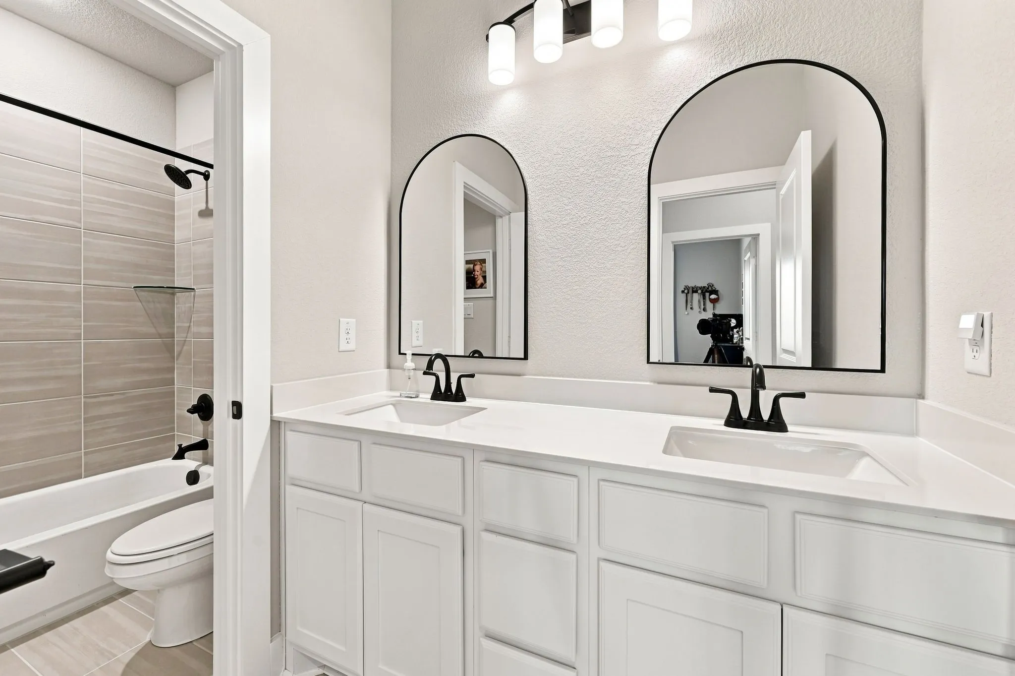 Hall bath with dual sinks and sperate bath area.