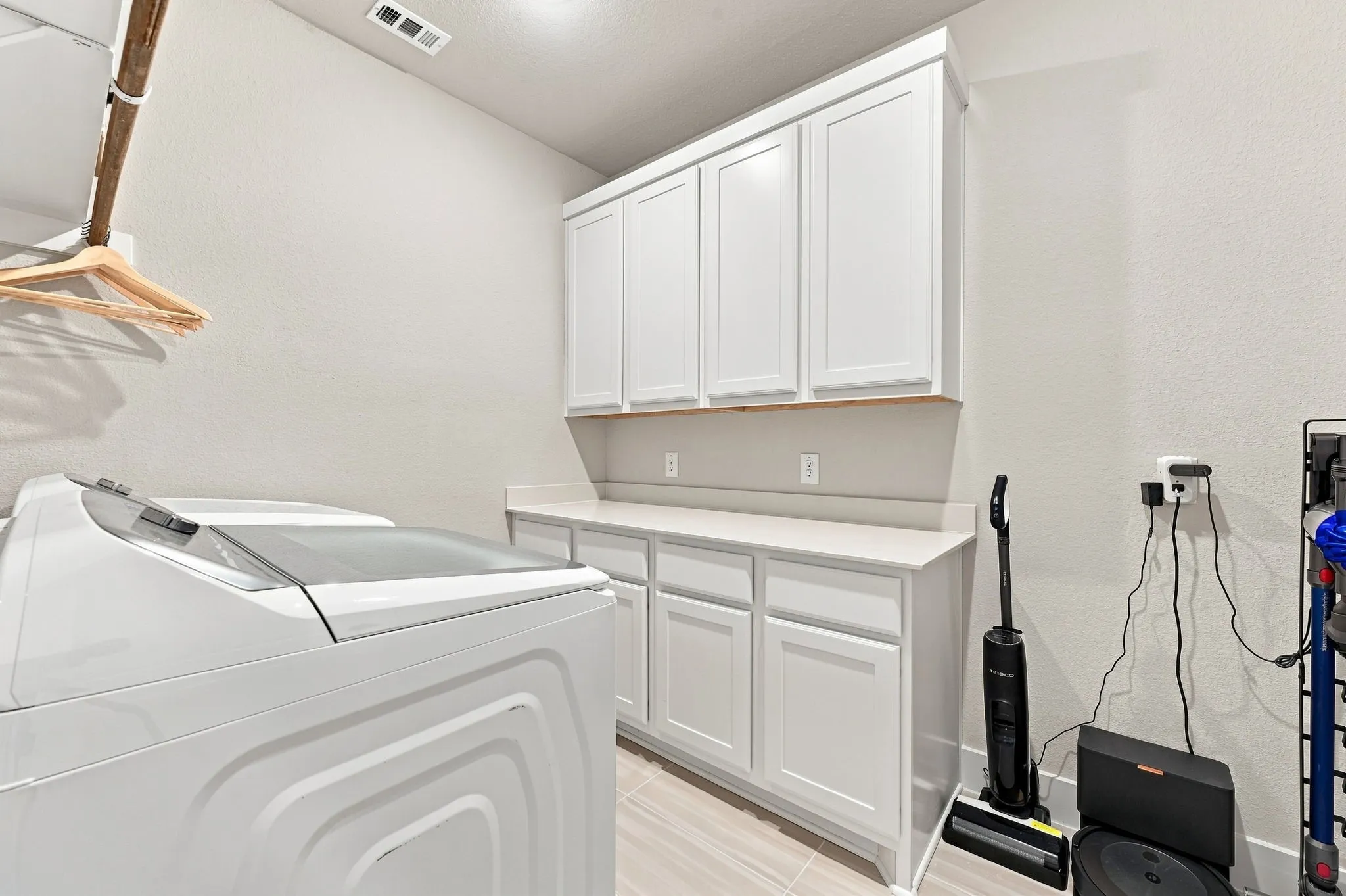 Good size laundry room with lots of cabinets.