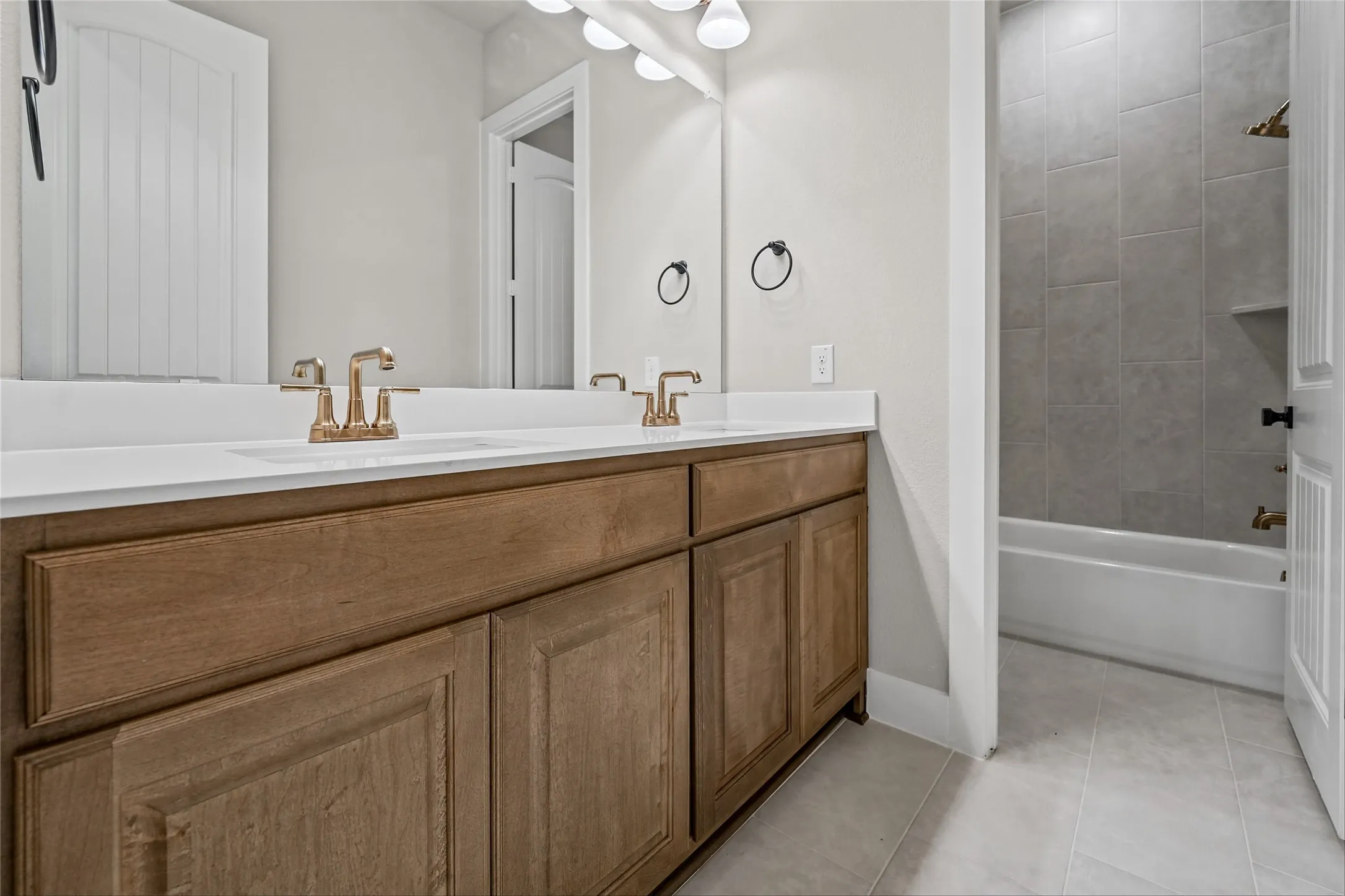 Dual vanity with wood-finish cabinetry and white countertops