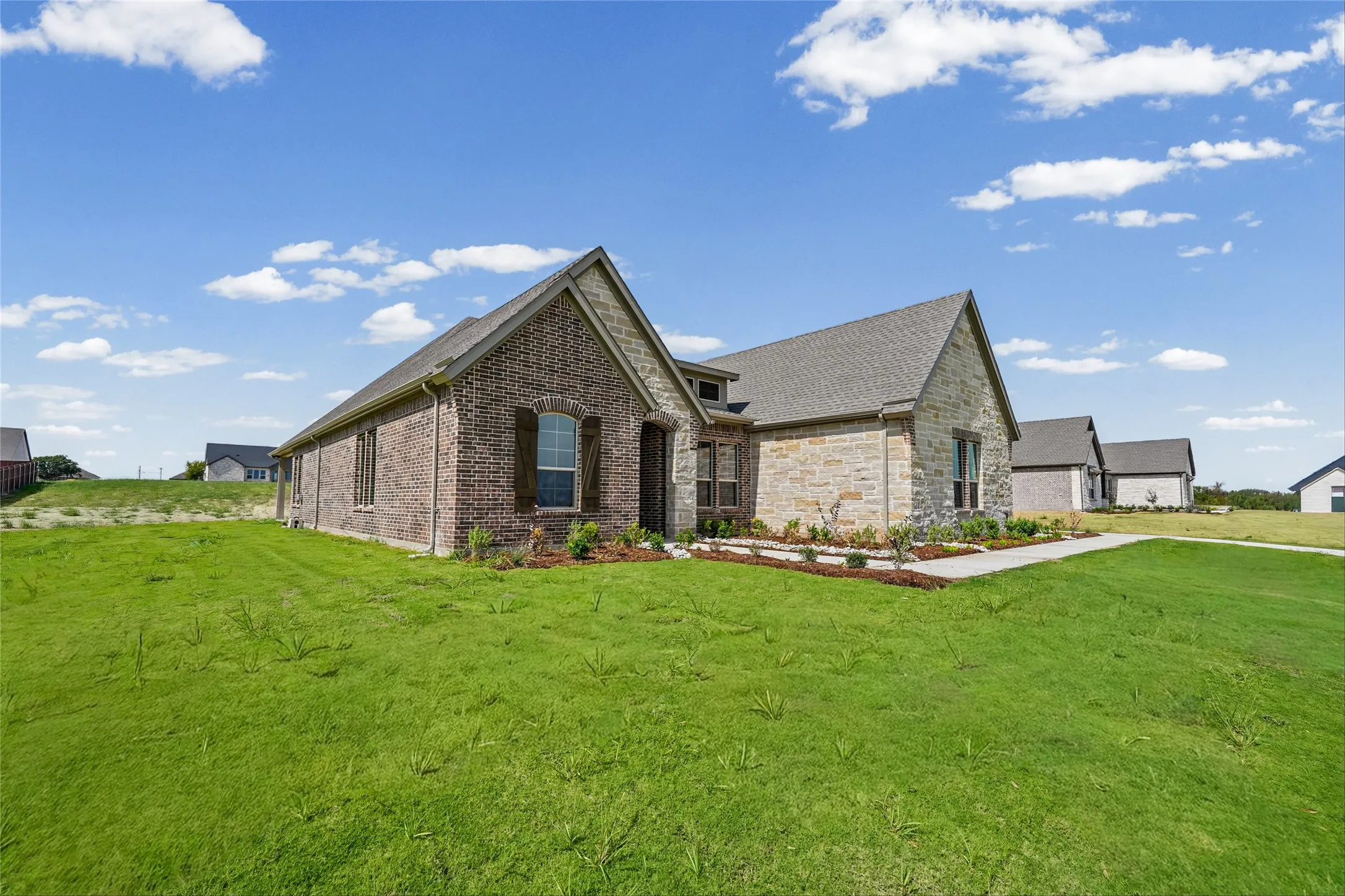 Brick and stone veneer exterior with gabled roofline