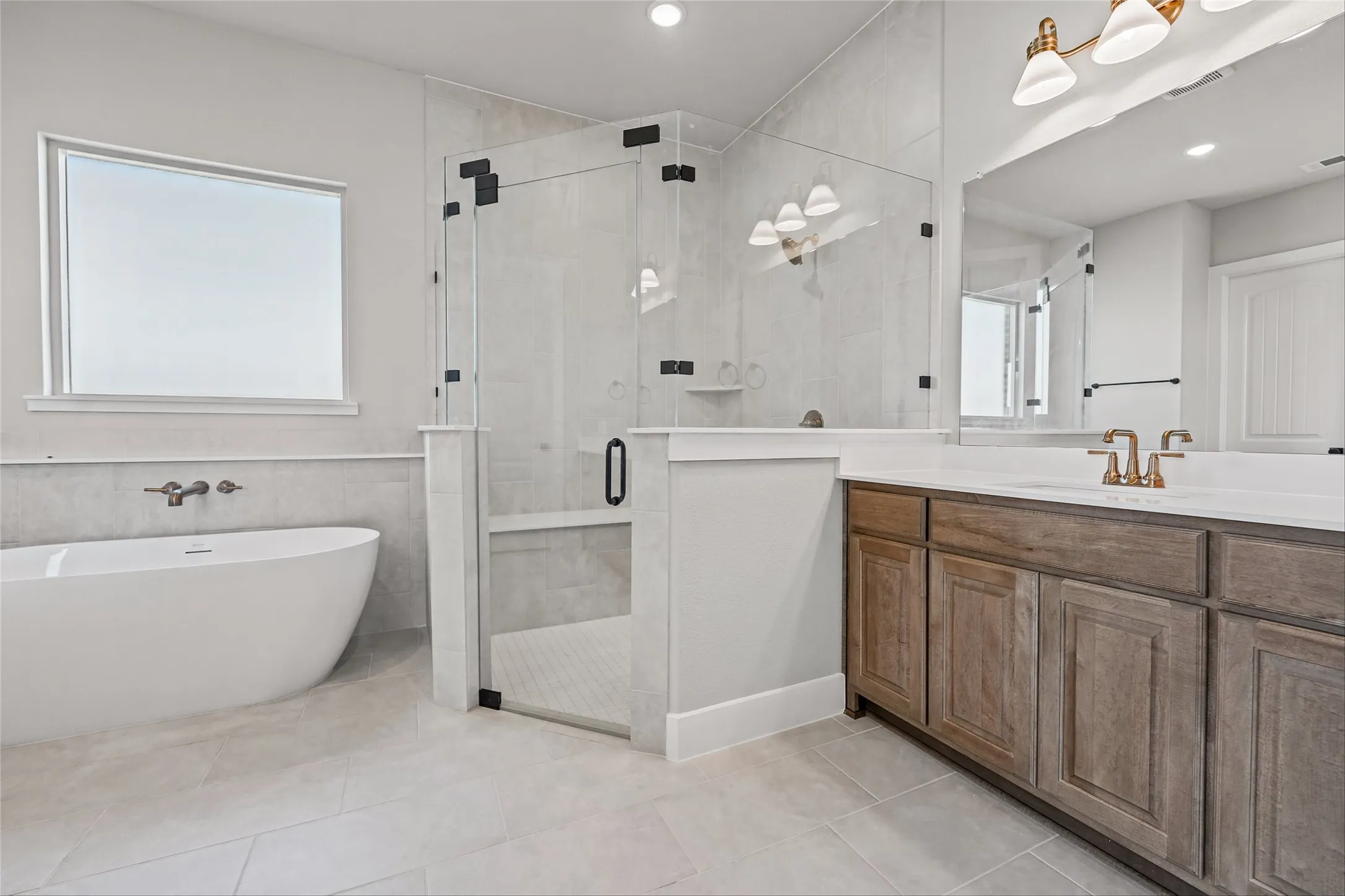 Freestanding soaking tub with wall-mounted faucet