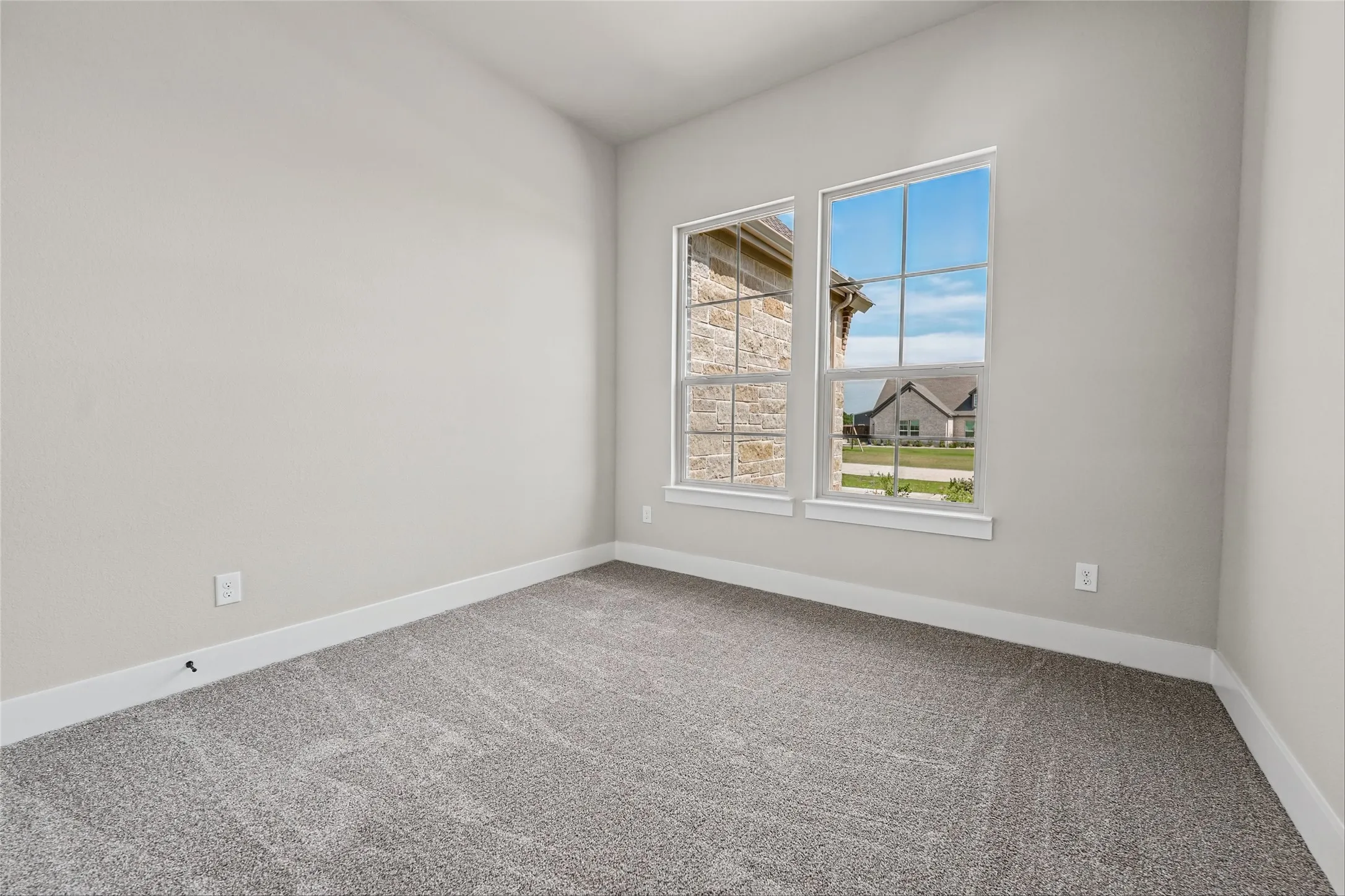 Neutral painted walls, gray carpet, and white trim