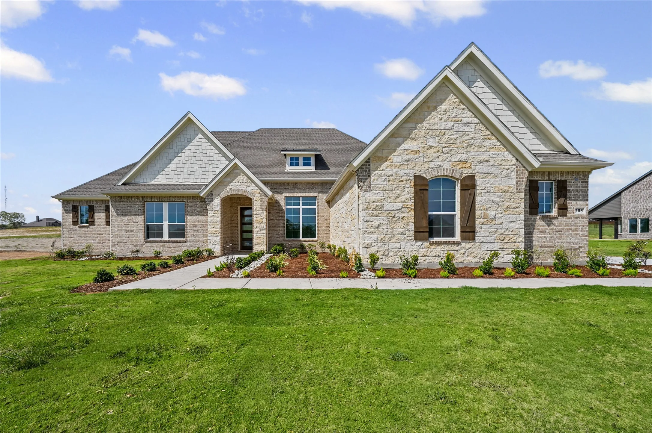 Stone and brick exterior with a gabled roofline