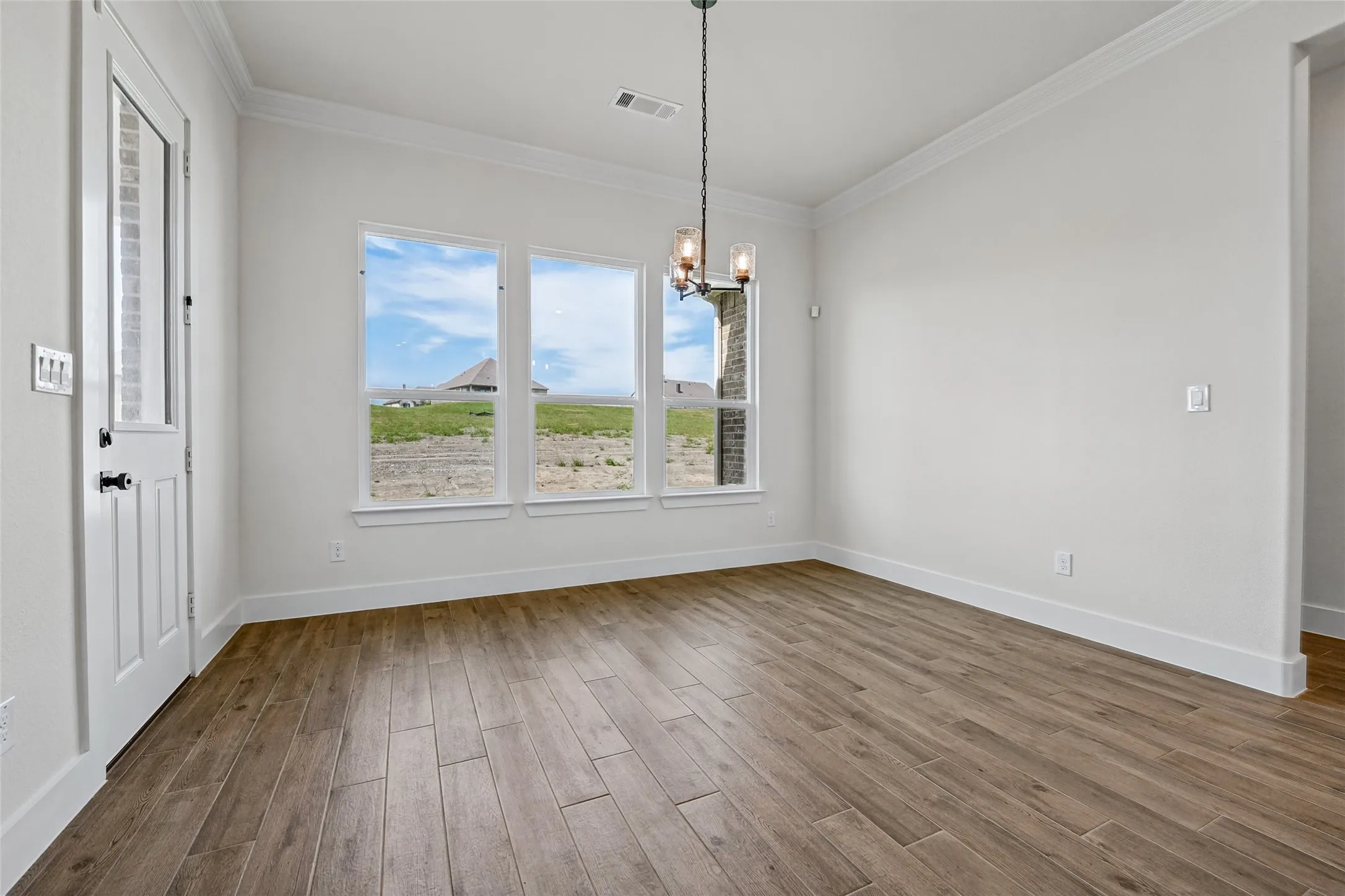 Wood-finish flooring with crisp white baseboards