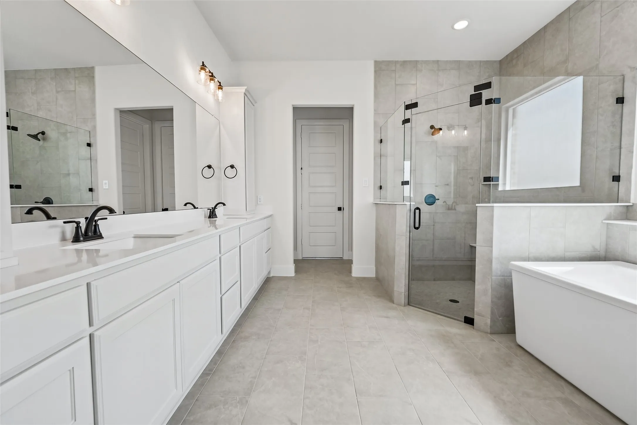 Dual vanity with white cabinetry and integrated sinks