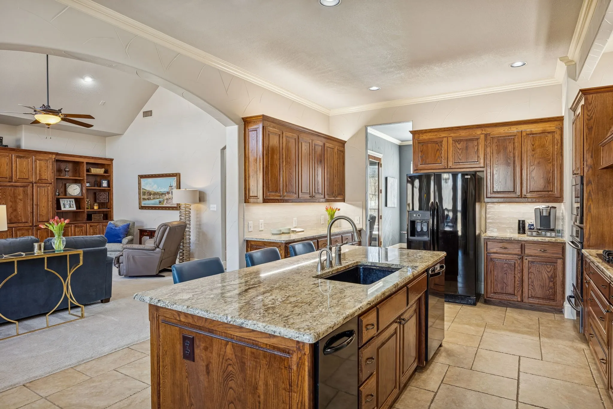 Spacious kitchen with ample prep space, granite countertops, custom cabinetry, and easy flow into adjacent living areas.