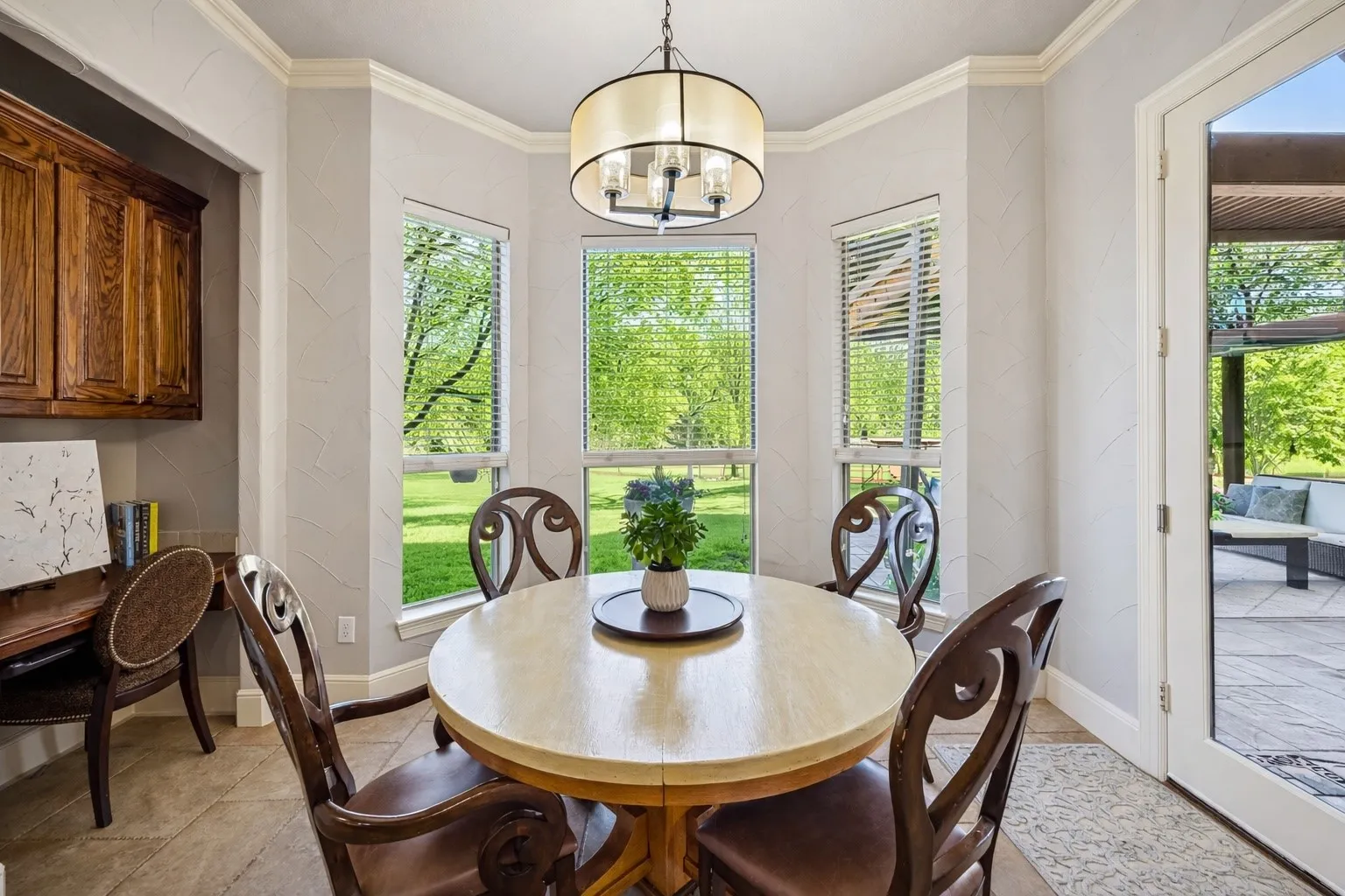 Charming breakfast area off the kitchen is surrounded by lovely bay windows offering a bright and cheerful setting with views of the lush backyard.