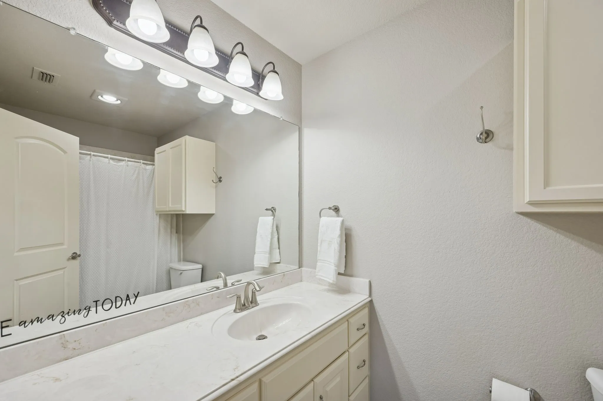 Ensuite Bathroom to bedroom 4 upstairs has tub and shower, long countertop and ample cabinet storage.
