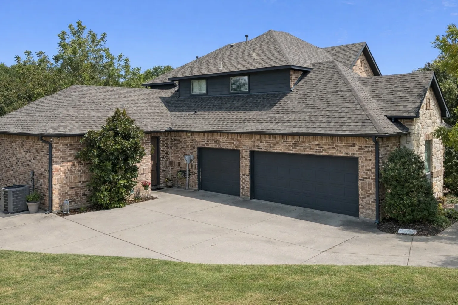 Spacious 3-car garage with extended driveway, providing ample parking and storage space for vehicles, equipment, or hobbies.