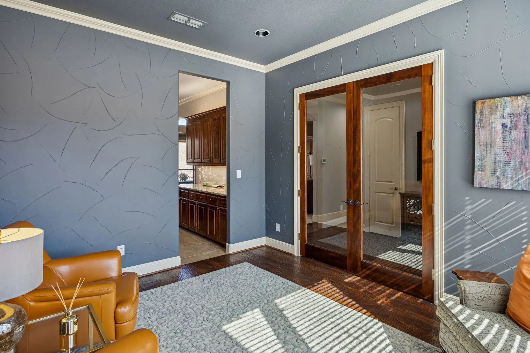 Beautiful glass French doors adorn this multi-use room which could be used as a study off the front door, a formal dining off the kitchen, or a living/sitting room to enjoy the morning sun.