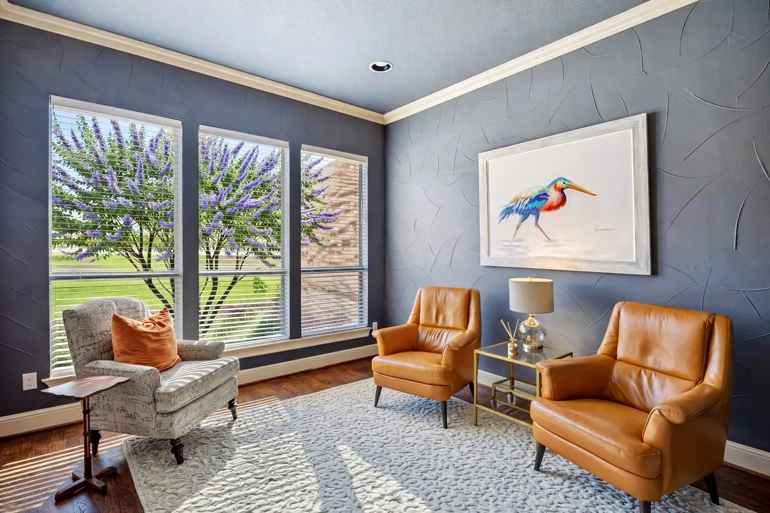 This inviting flex space features rich designer wall finishes, stunning dark hardwood floors, abundant natural light, and large windows overlooking beautifully landscaped grounds.