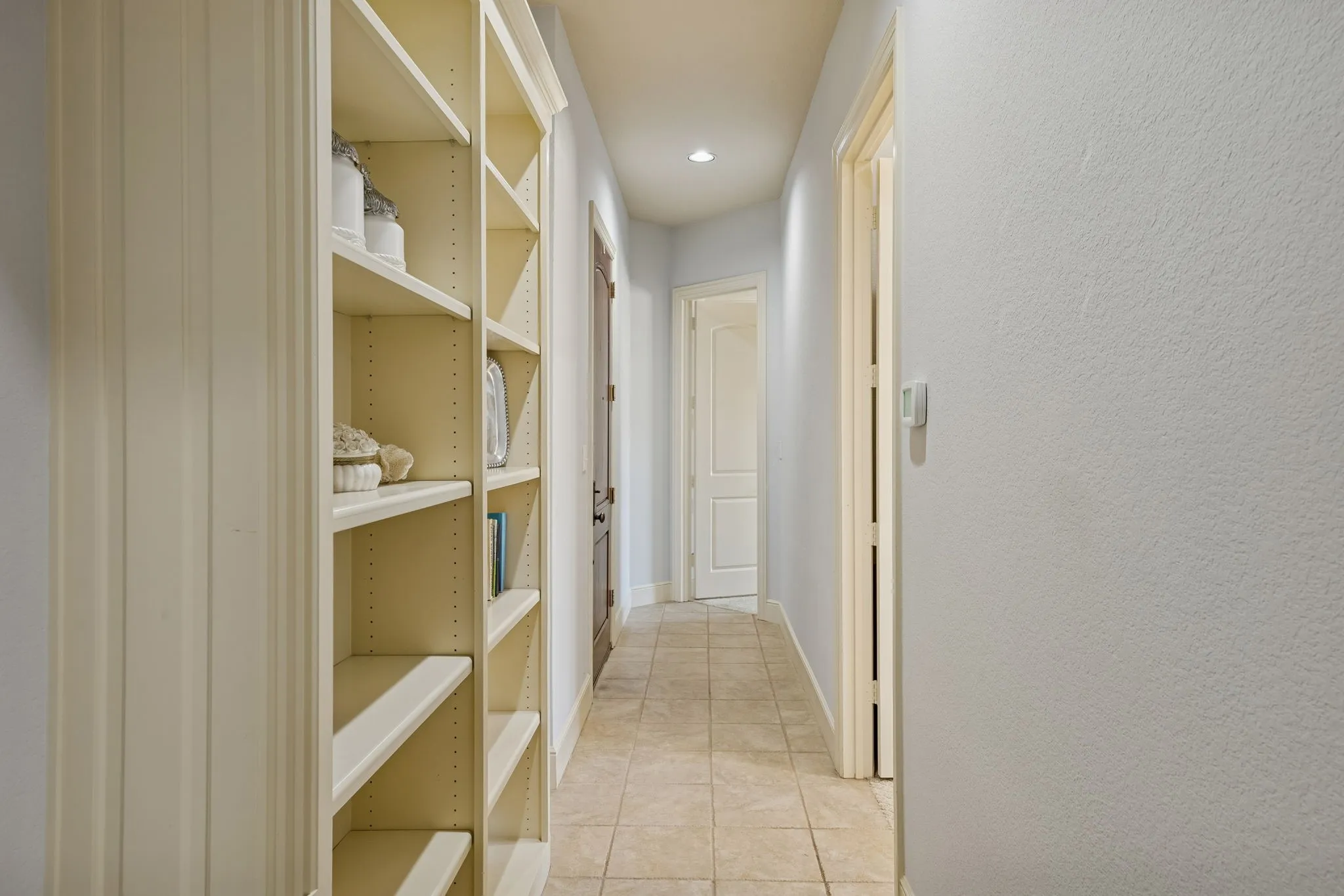 Built in bookcases in the back hall across from the office serves a great storage and function of this full service suite.