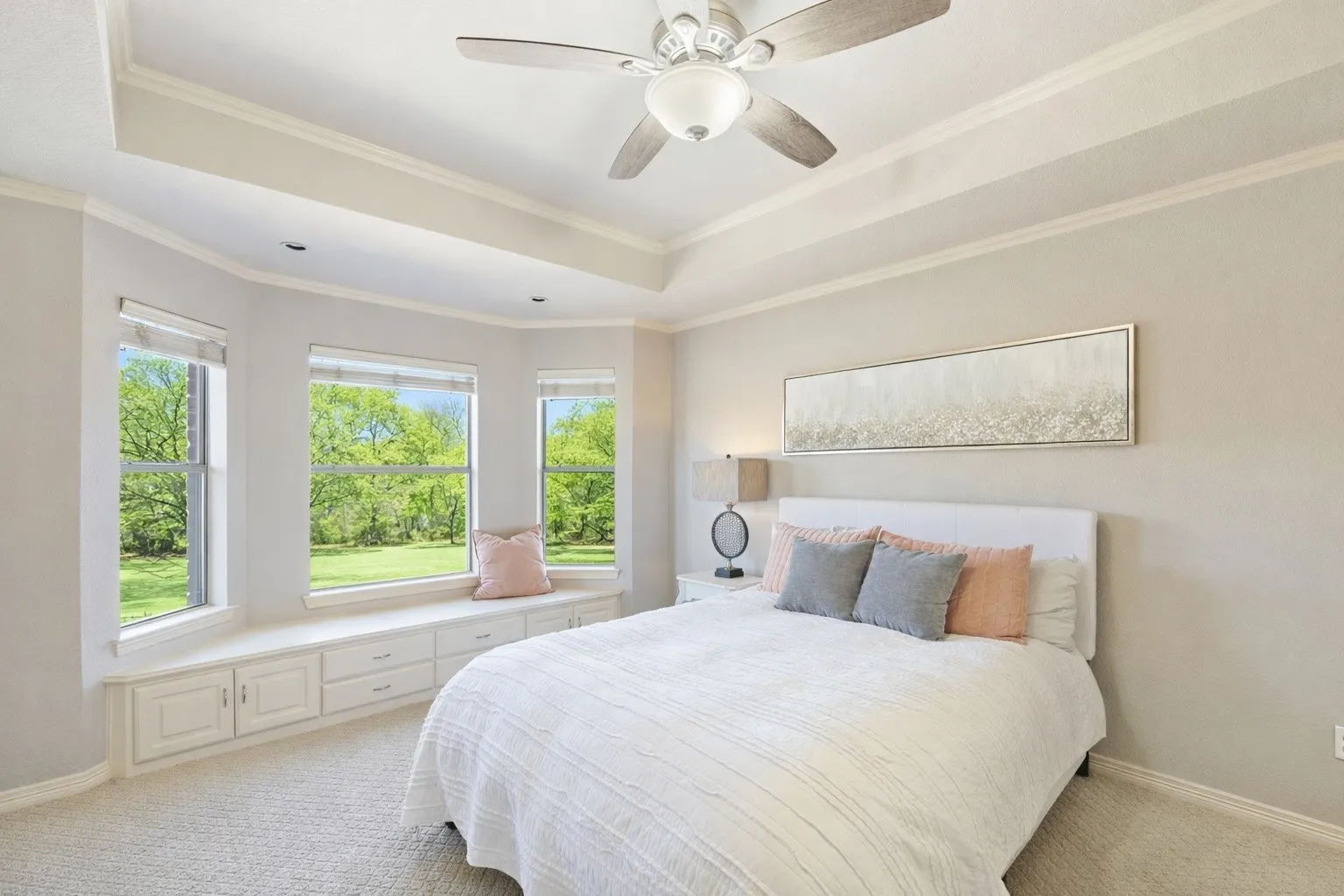 The spacious secondary bedroom has an ensuite and is on the second floor and features a large bay window, neutral tones, and plenty of natural light—ideal for guests or family. Notice the cozy window seat—perfect for relaxing!
