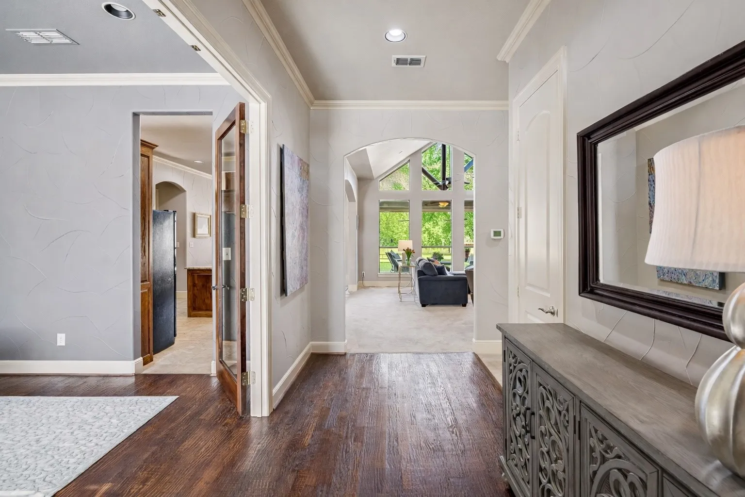 This welcoming entry way has rich hardwood flooring and sightlines into the main living space for an open, elegant feel. The formal dining room (currently being used as a sitting room) is to the left of the entry.