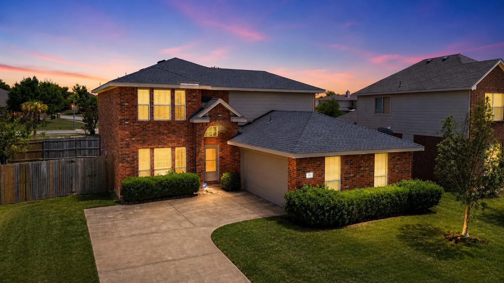 Traditional brick and siding exterior with a two-car garage