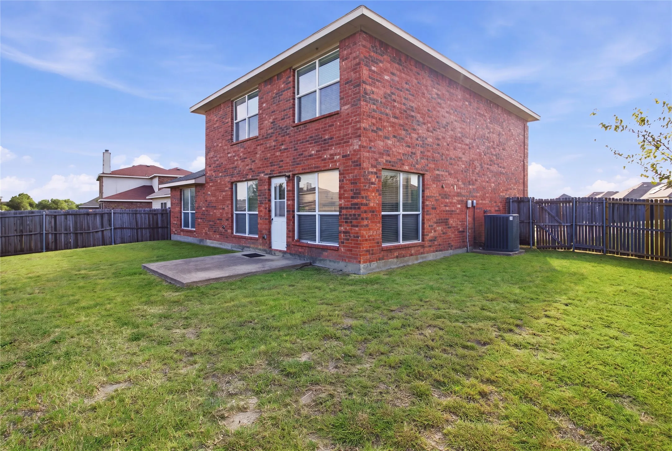 Red brick exterior featuring a multi-story design and white-framed windows