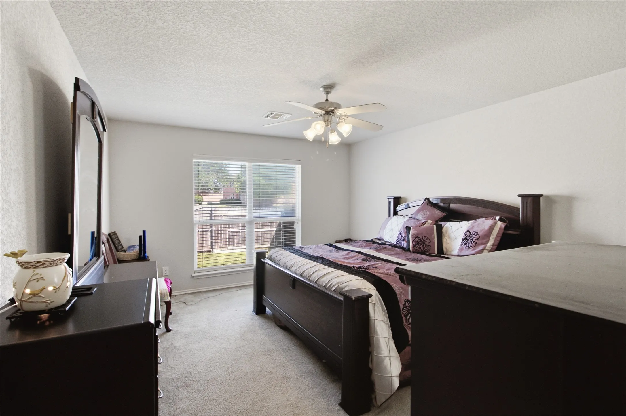 Carpeted room with a ceiling fan, a window with blinds, and white walls