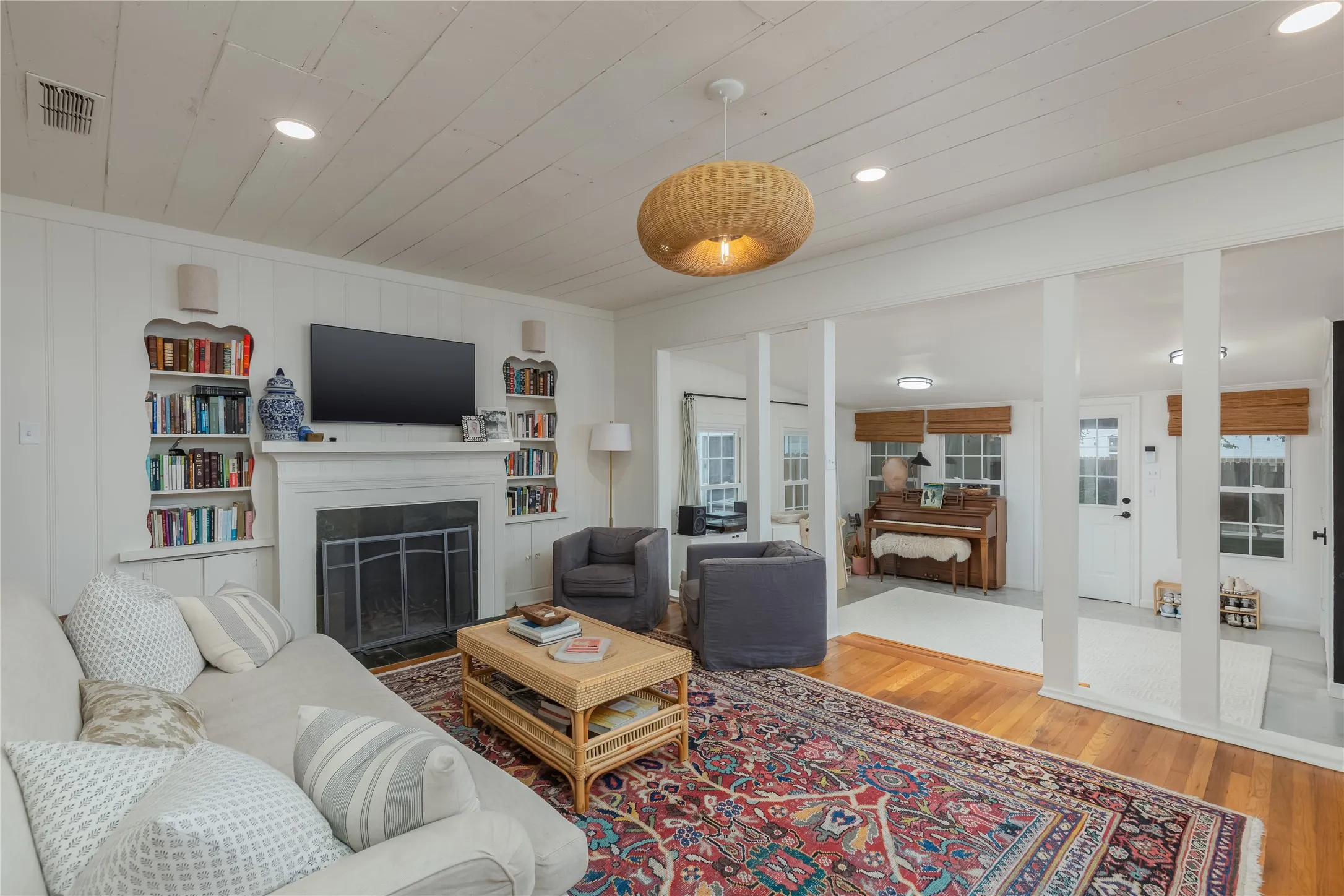 Living area featuring wood-finish flooring and a white shiplap ceiling