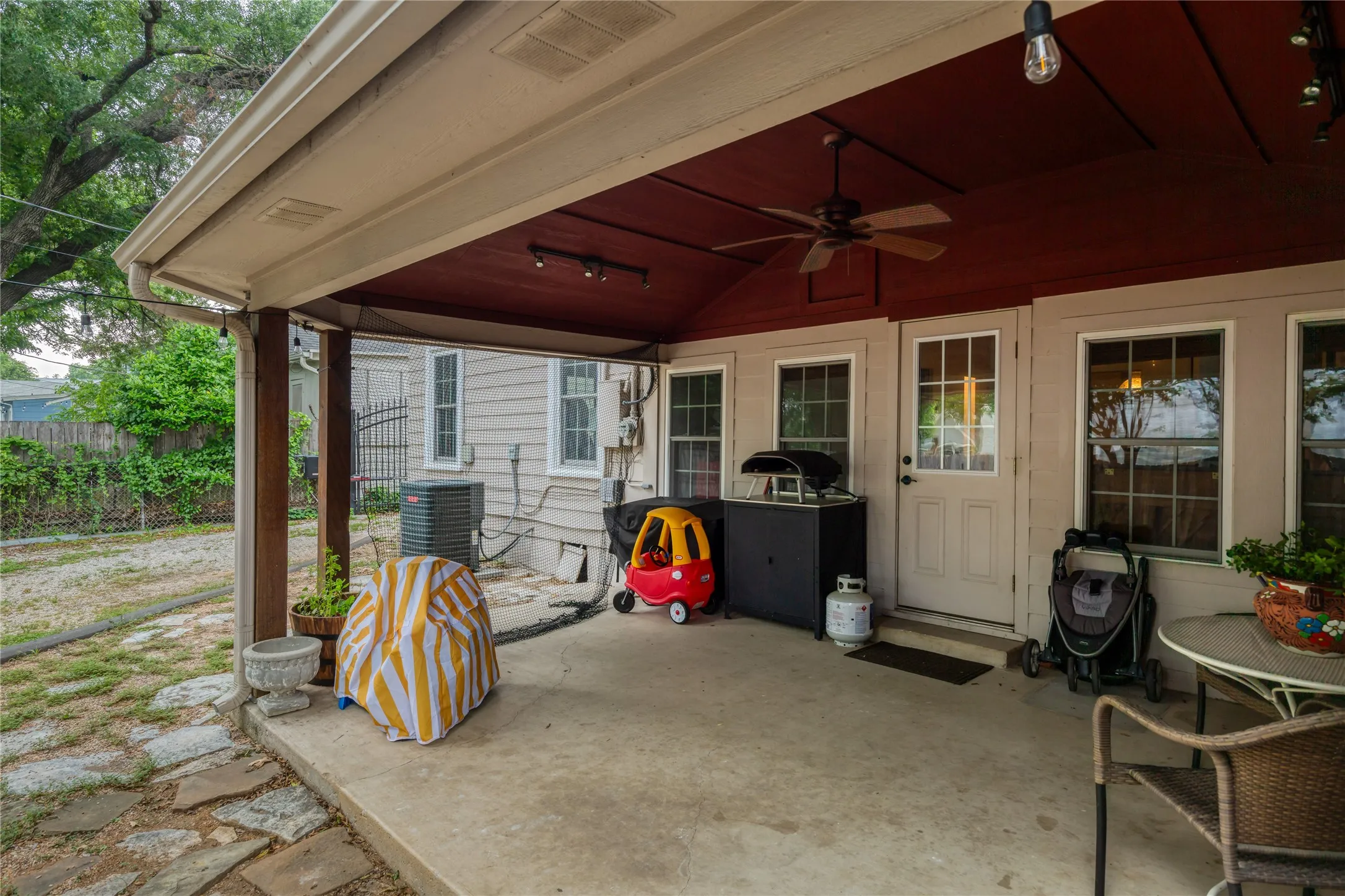 Covered patio featuring a ceiling fan, recessed lighting, and a red-painted ceiling