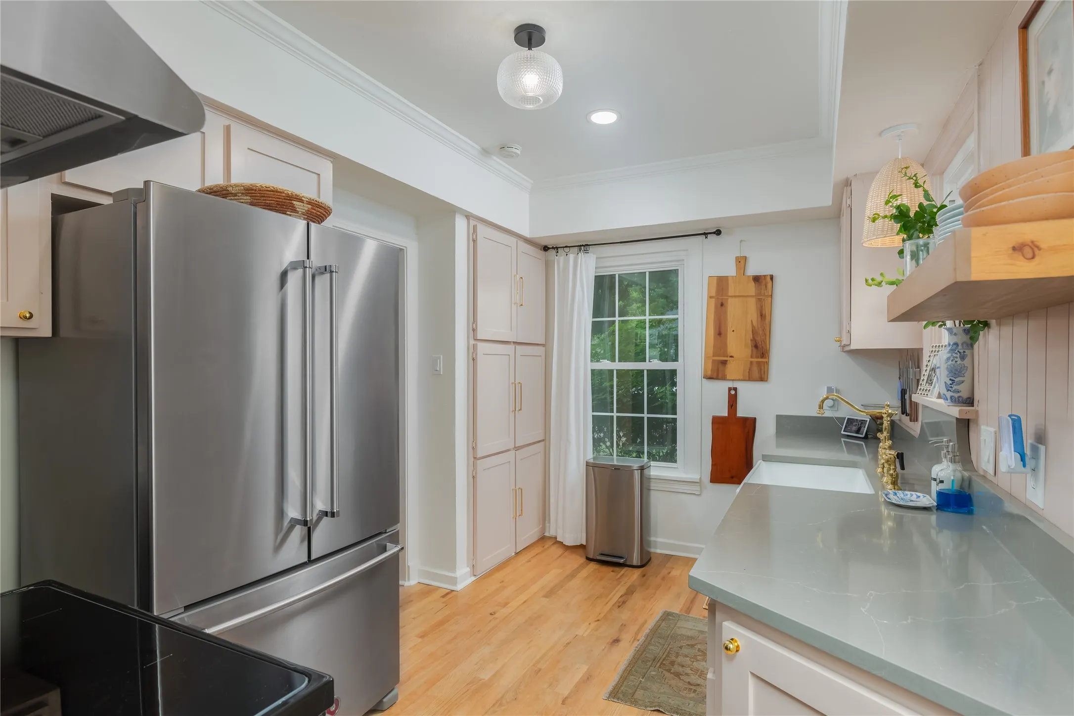 Stainless steel French door refrigerator set into custom cabinetry