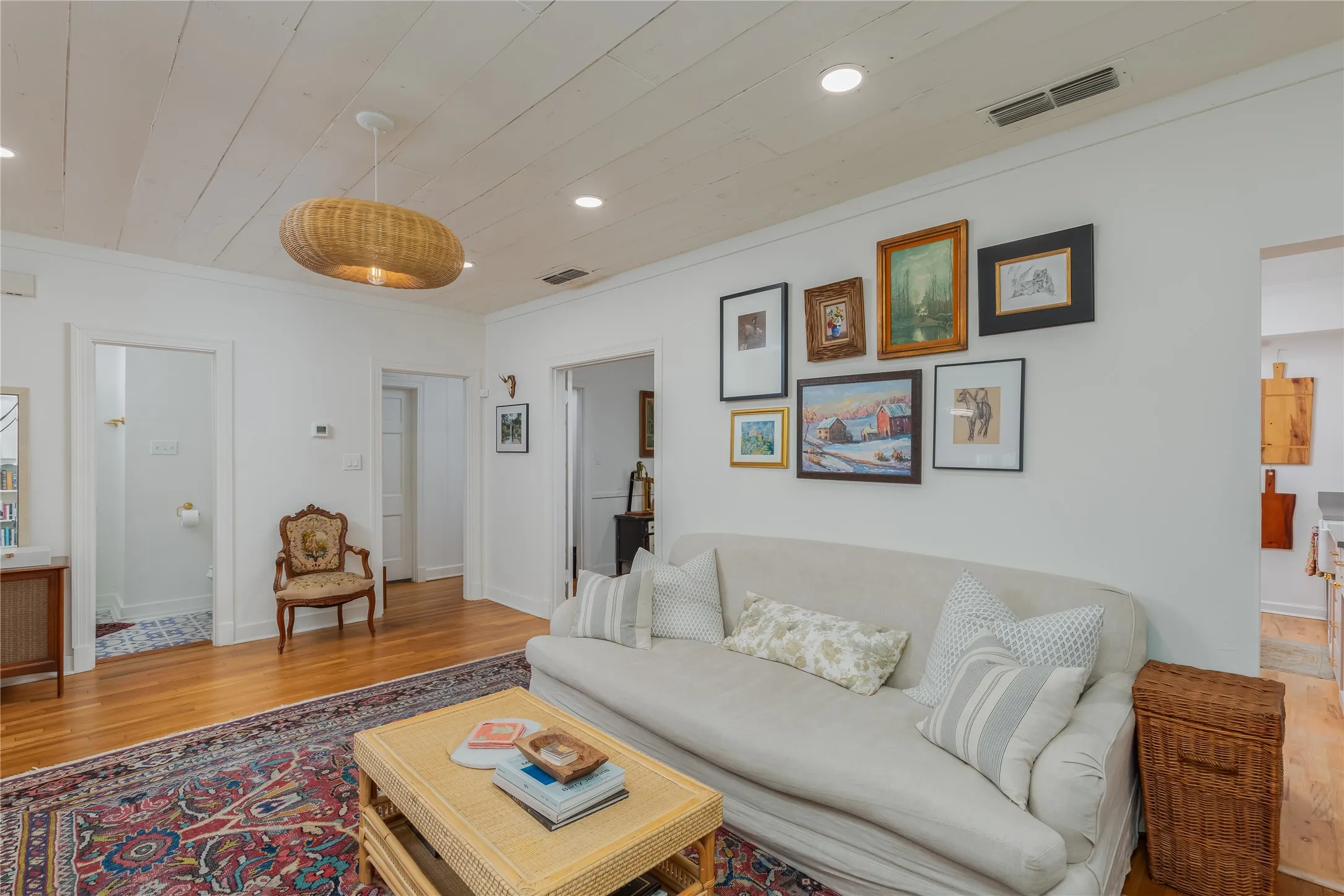 Hardwood flooring featuring an area rug, white painted wood plank ceiling, recessed lighting, and a woven pendant light fixture