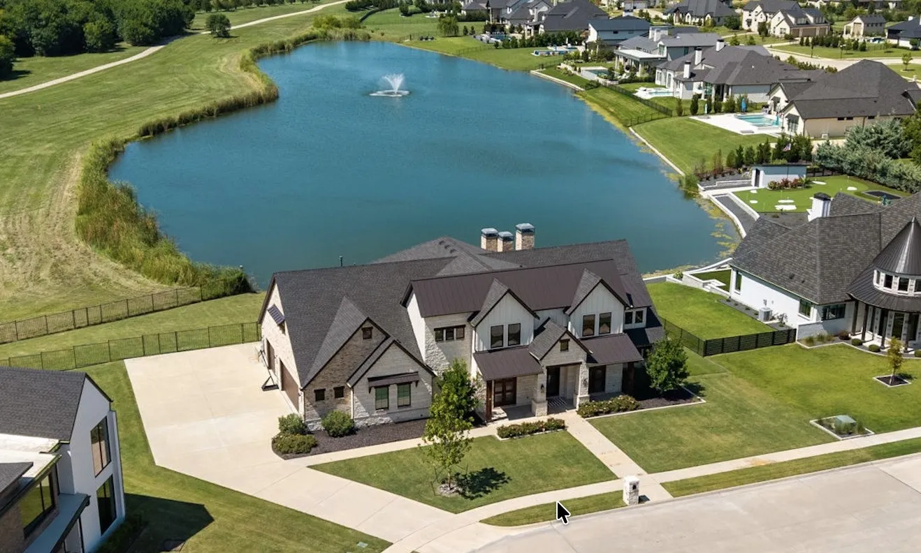 Stunning two-story residence showcasing a brick and stone exterior with multiple gabled rooflines and architectural detail