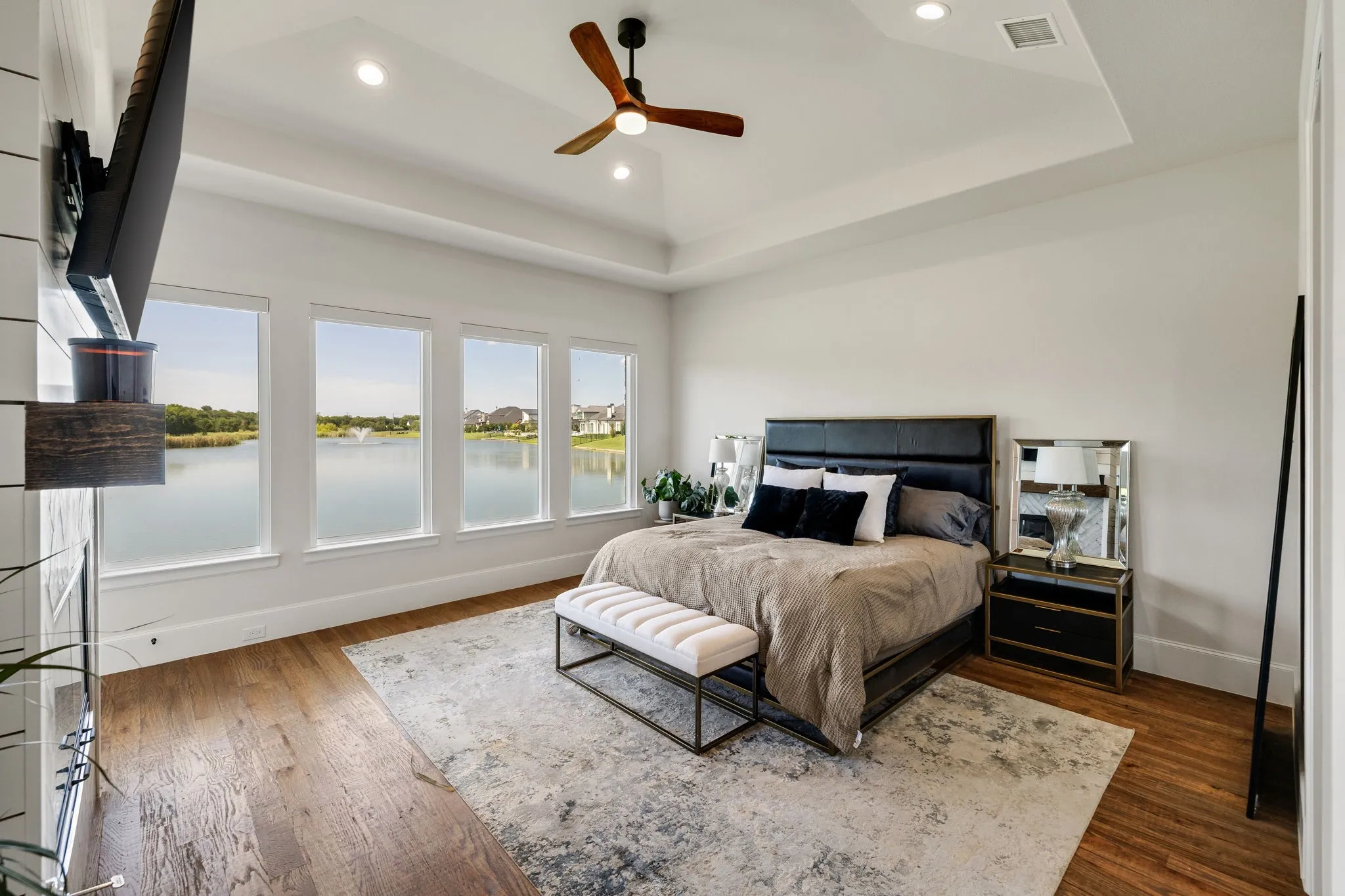 Four large windows showcasing the lakefront scenery