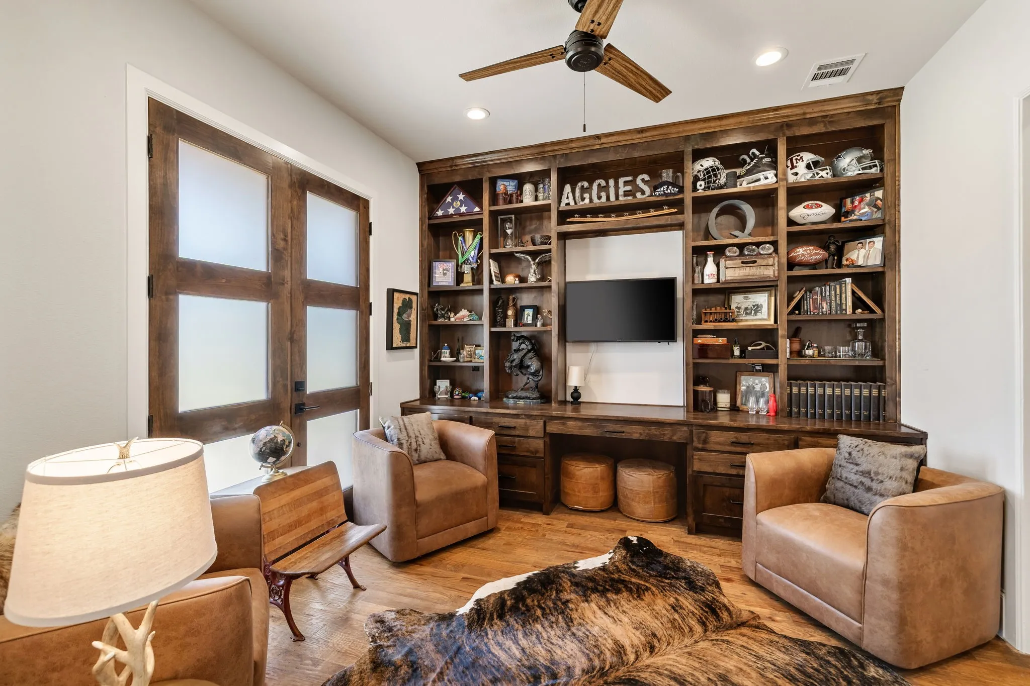 Built-in office with double opening doors to the front of the house right off the foyer.