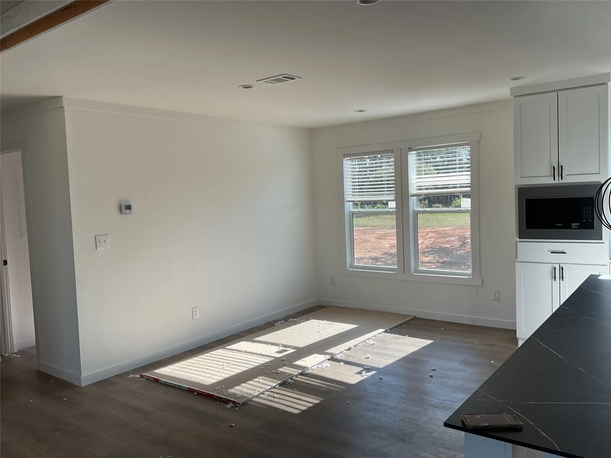 Bright interior space featuring wood-finish flooring, white walls, and recessed lighting
