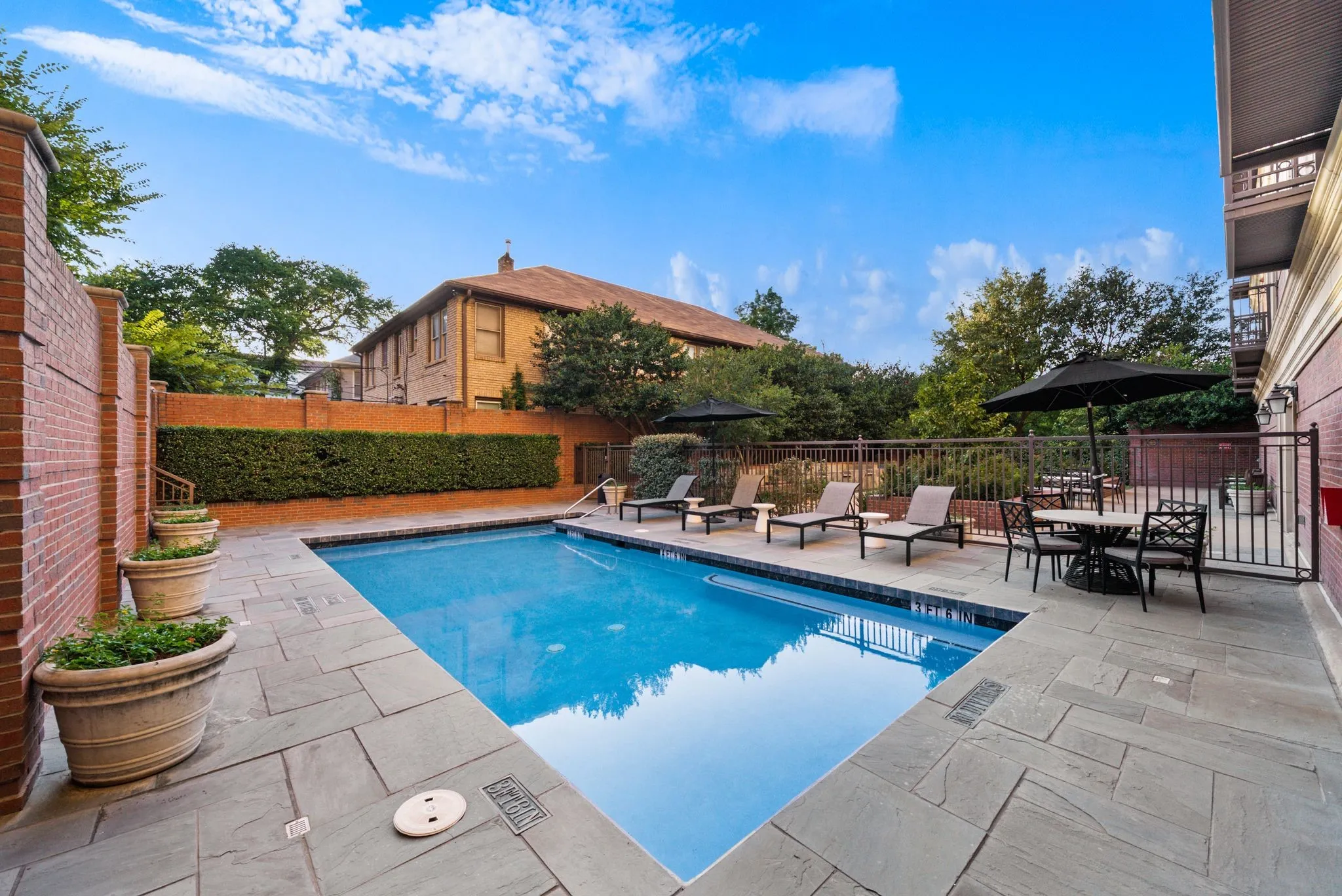 Outdoor swimming pool with a surrounding stone patio