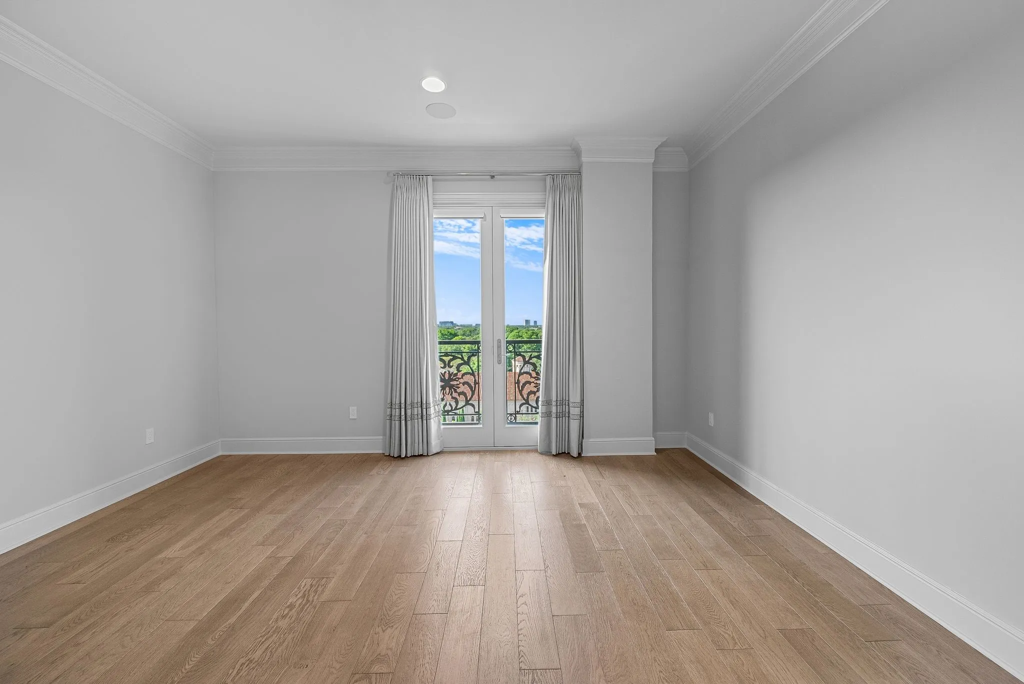 Light wood-finish flooring complements neutral wall tones