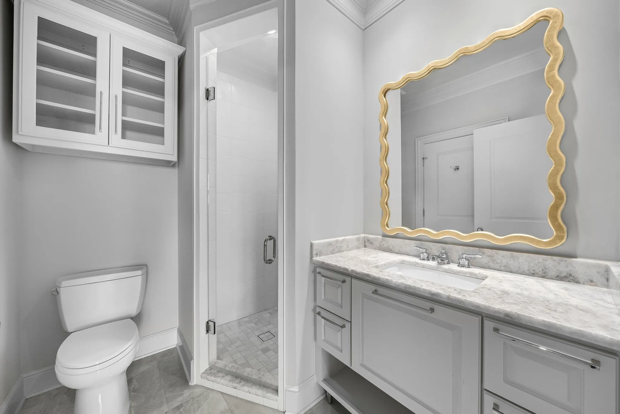 Bathroom featuring a white vanity with a light-colored countertop and undermount sink