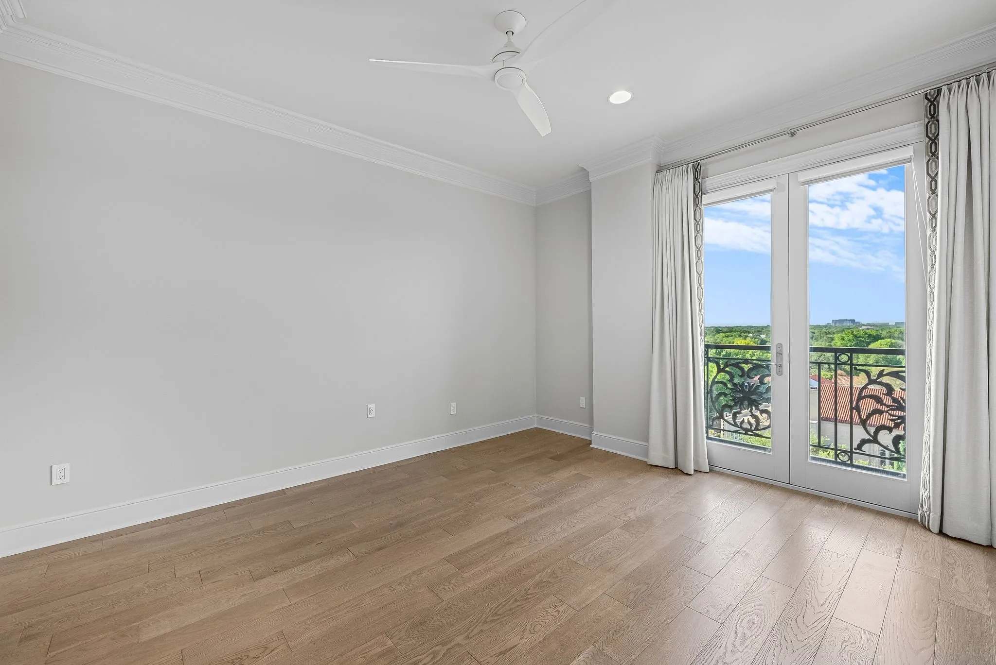 Room featuring light wood-finish flooring and crown molding