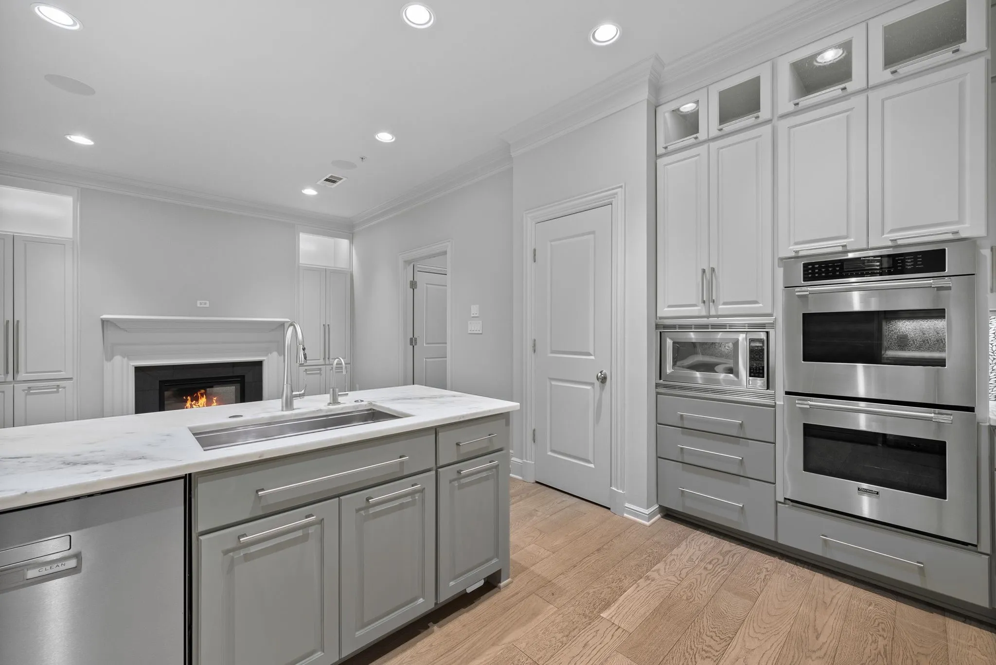 Expansive kitchen island featuring a stainless steel undermount sink and a dishwasher