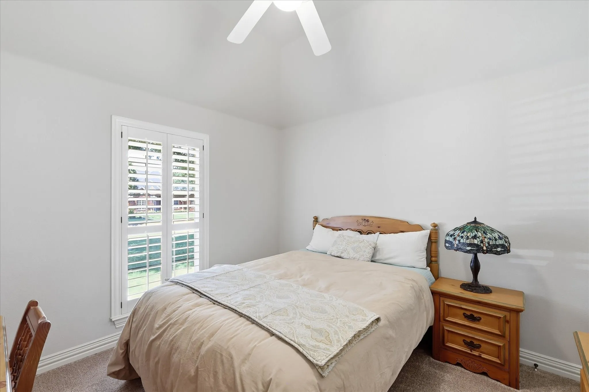 Bedroom 3. Ceiling fan, plantation shutters next to bath 2.