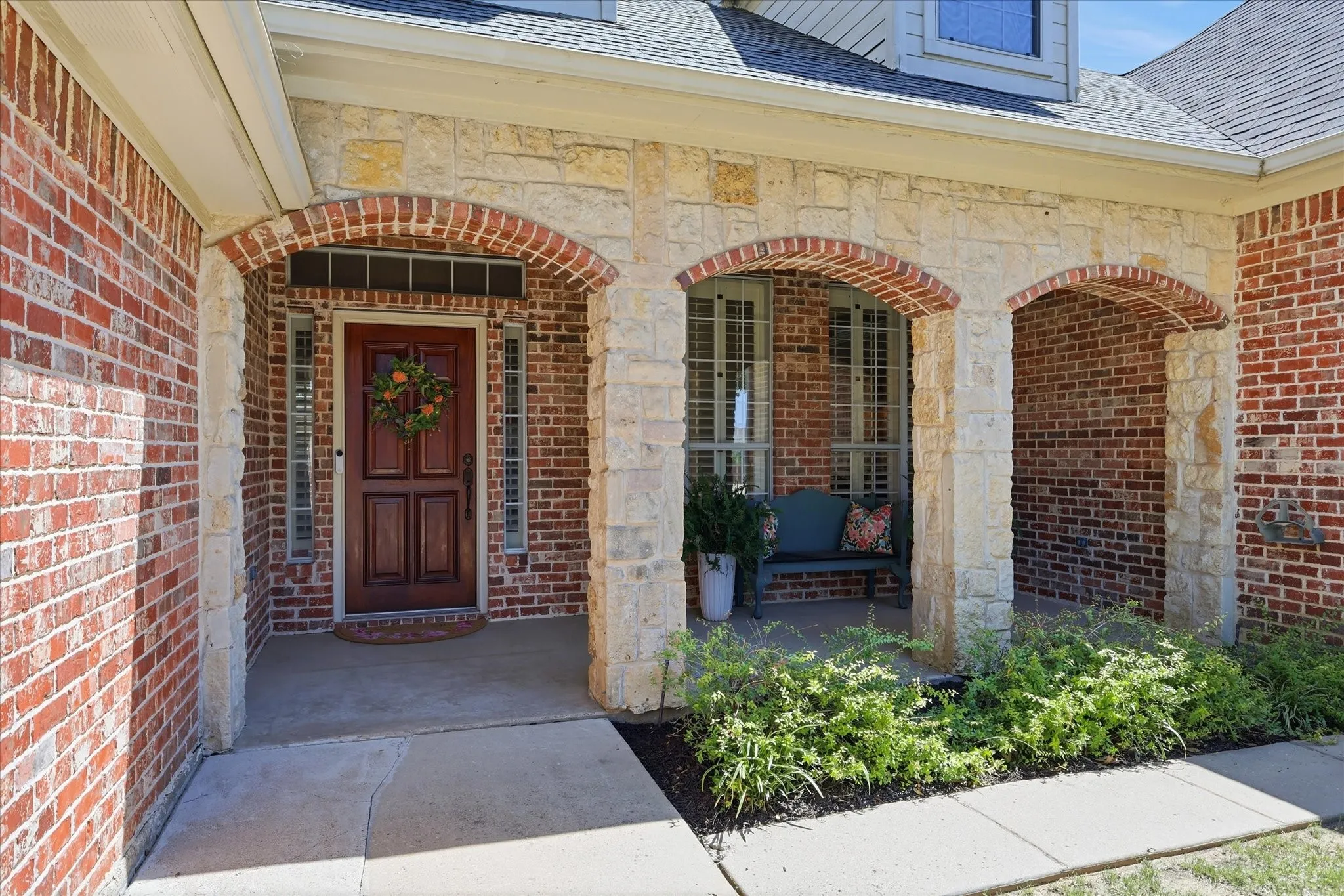 All brick and stone. Charming sitting area at the front.